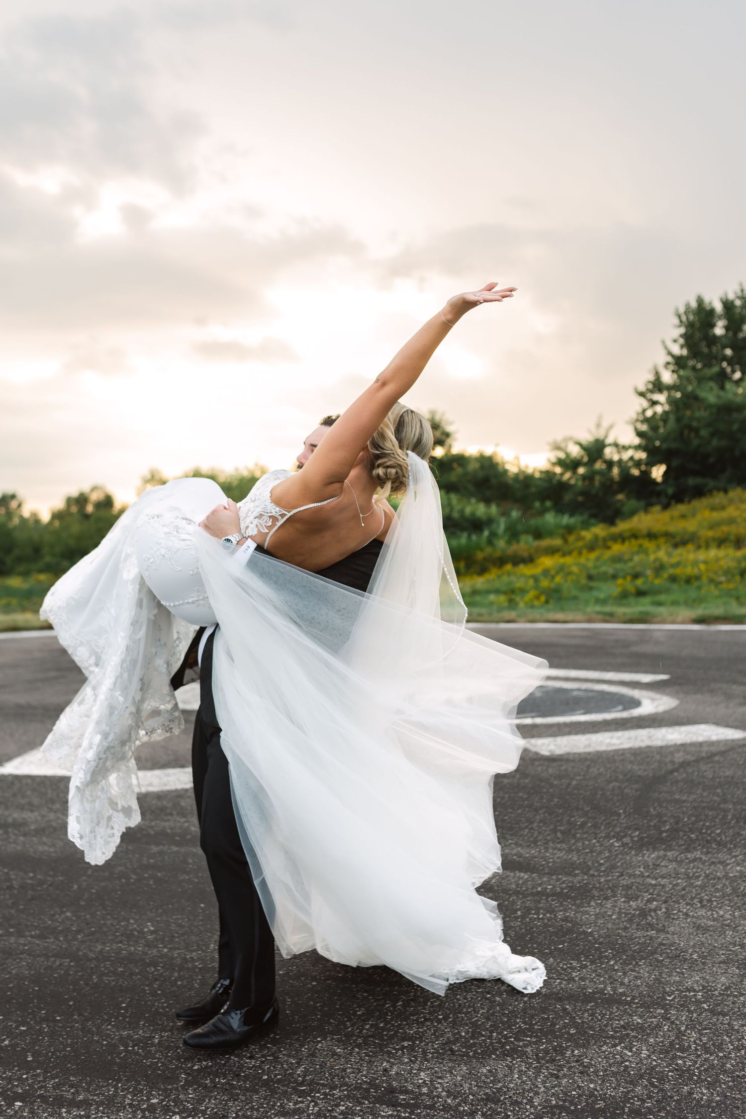 Candid bride and groom portraits on the helipad at Eagles Nest Golf Club in Toronto, photographed by a Toronto wedding photographer.