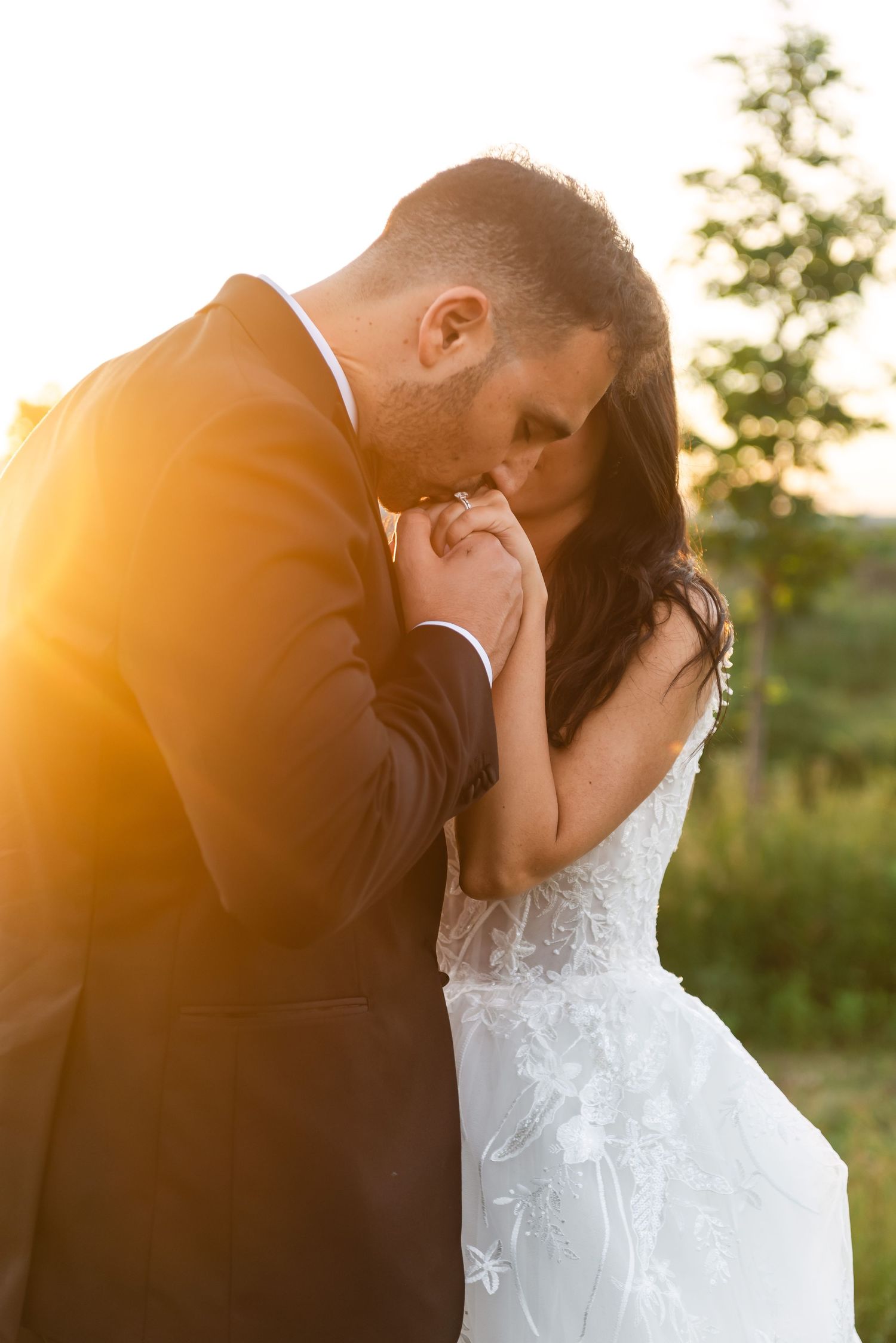 Romantic sunset wedding photos capture intimate moments between the newlyweds.