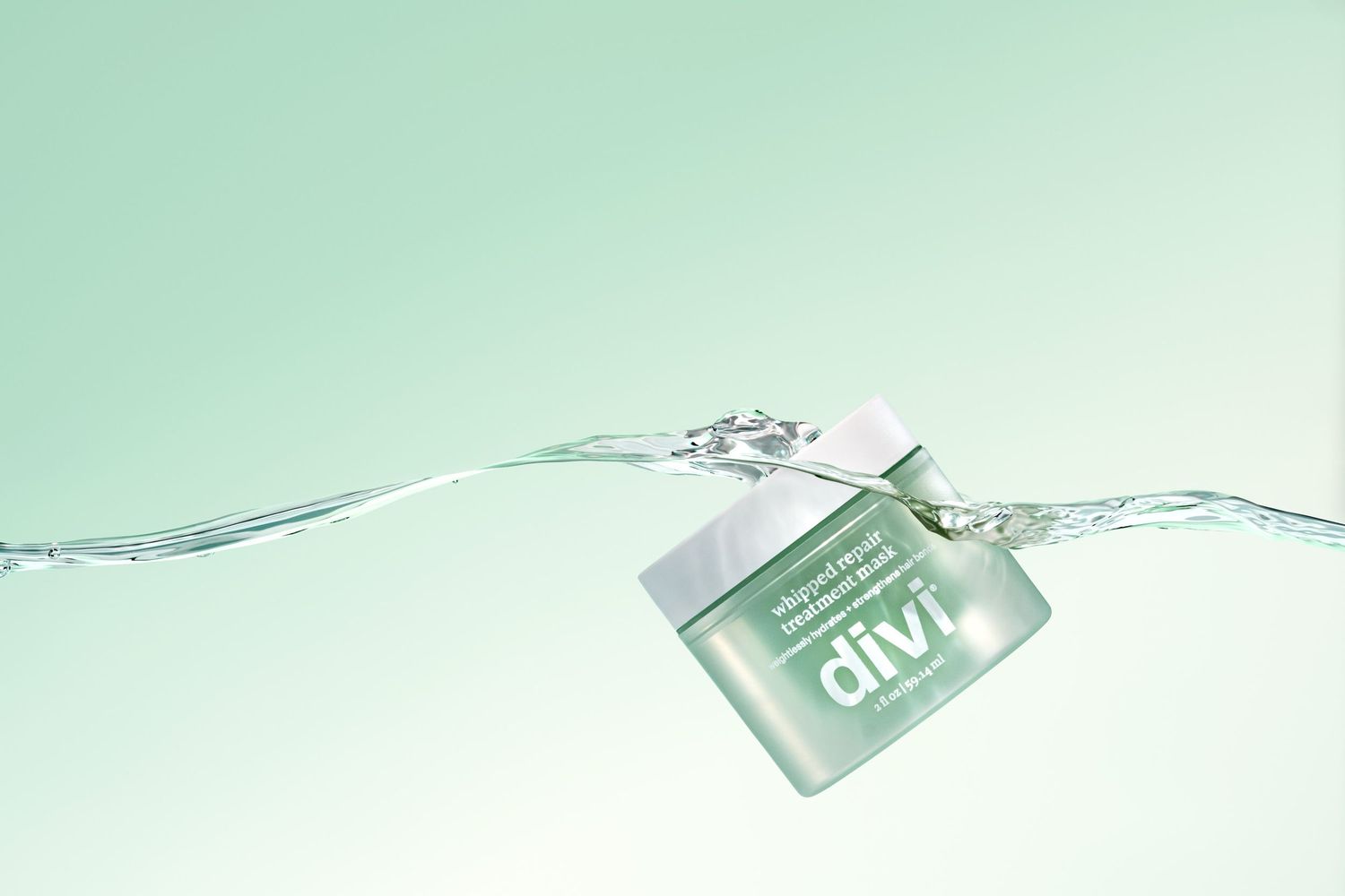 A Divi whipped repair treatment mask splashing in water with dynamic liquid motion effects and a matching color background. High end studio.
