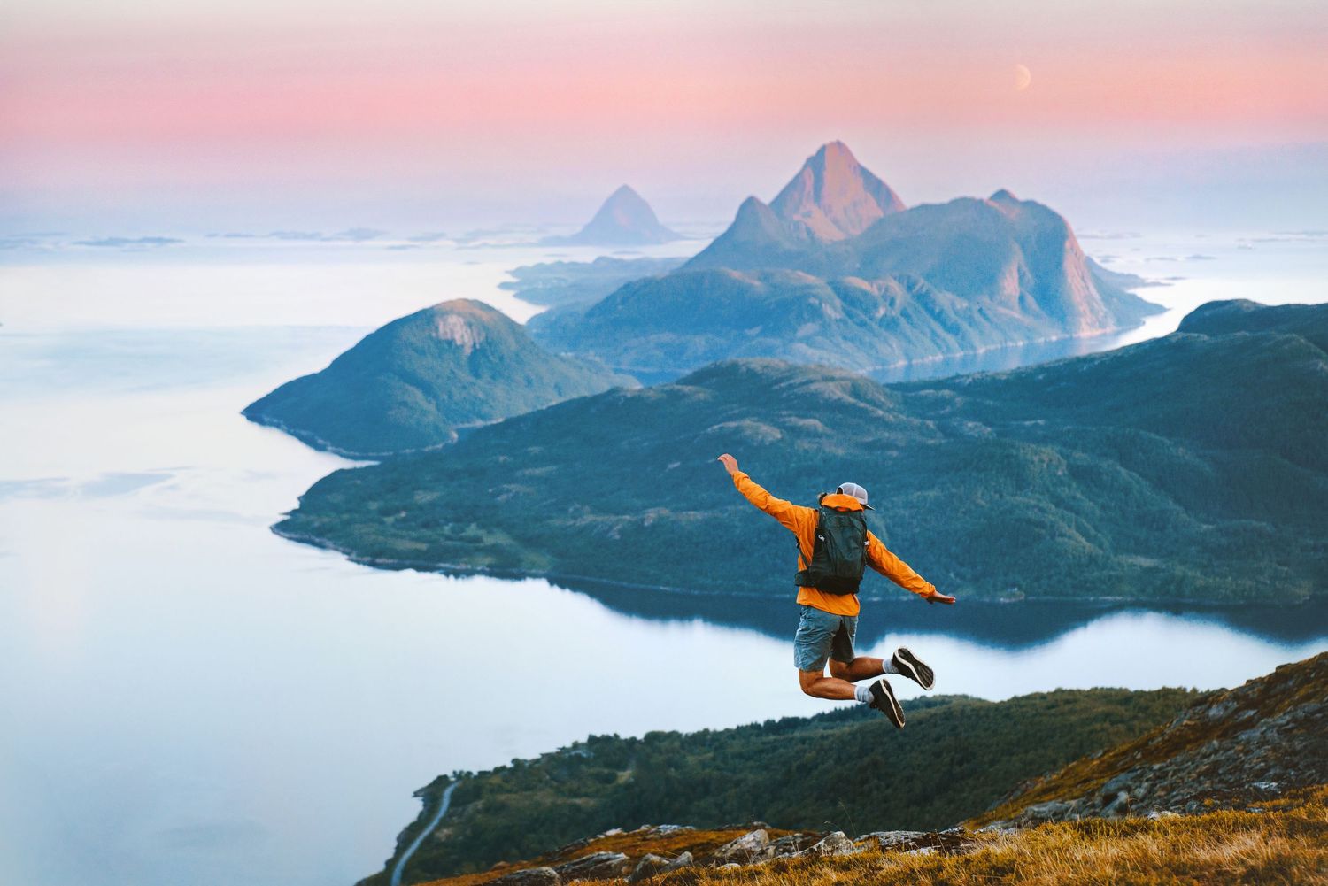 man standing in front of a mountain landscape