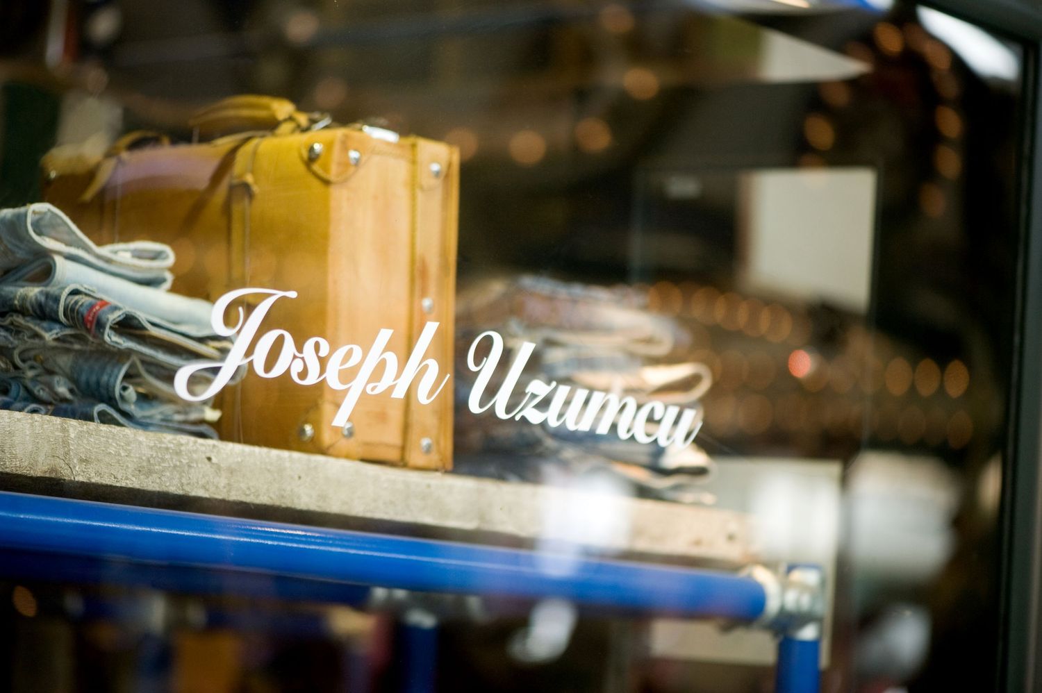 Storefront window with signage and lettering visible at night. Corporate Photography