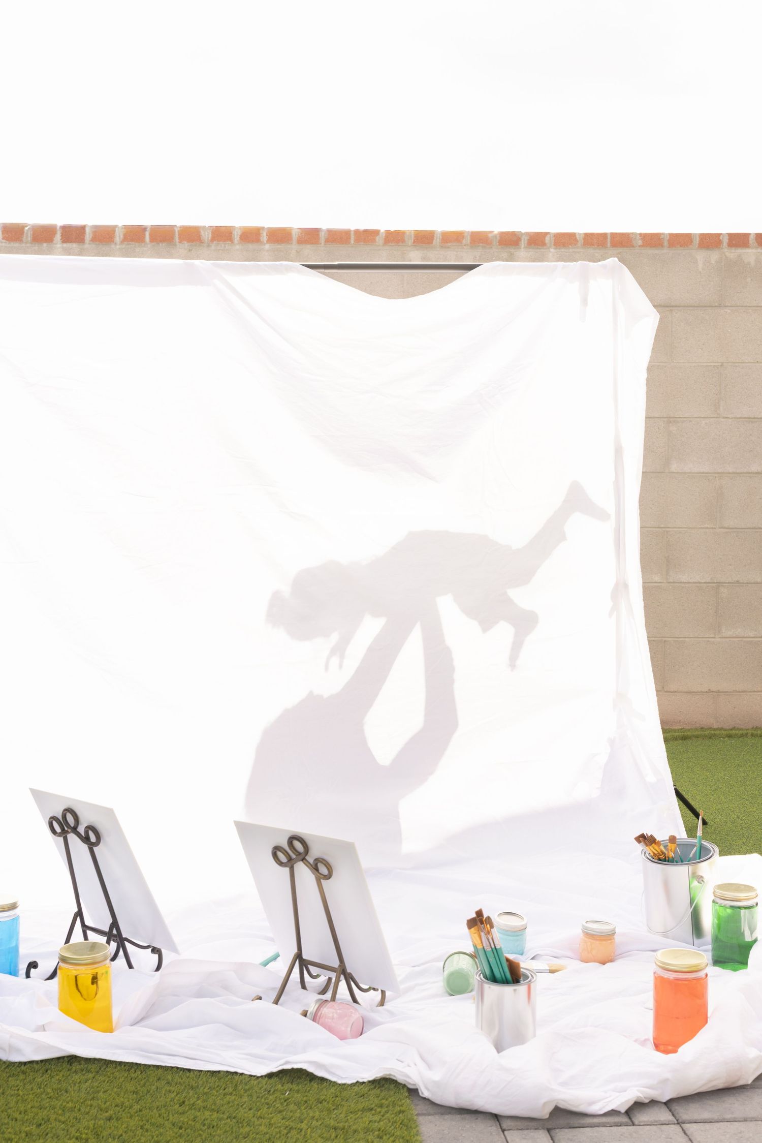 mommy and me shadow photography, painting set on a cloudy golden hour. mother daughter painting session