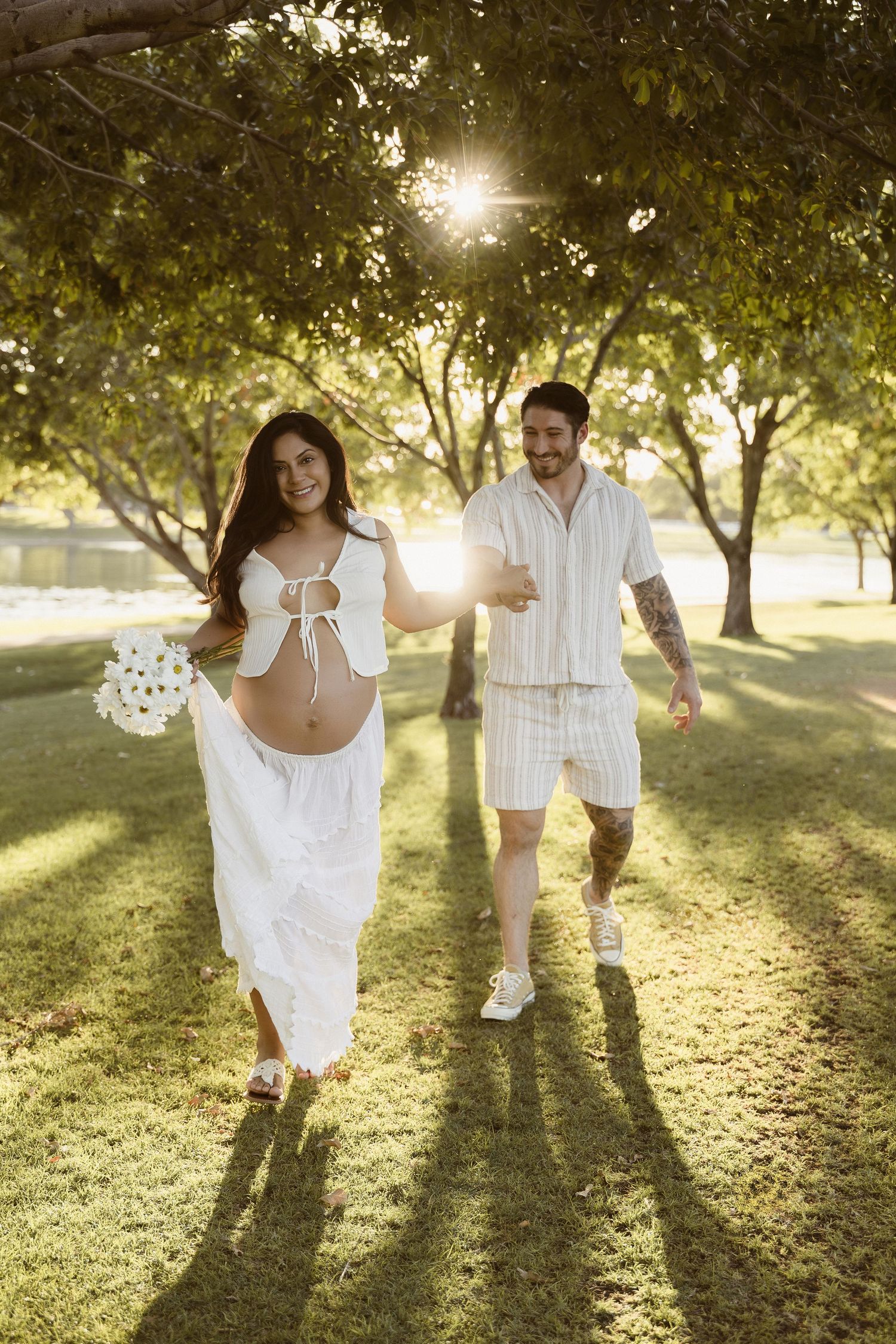 couple sunset maternity session in white boho dress and tie top, photographed at Four Silos Lake in Morrison Ranch, Gilbert, AZ.