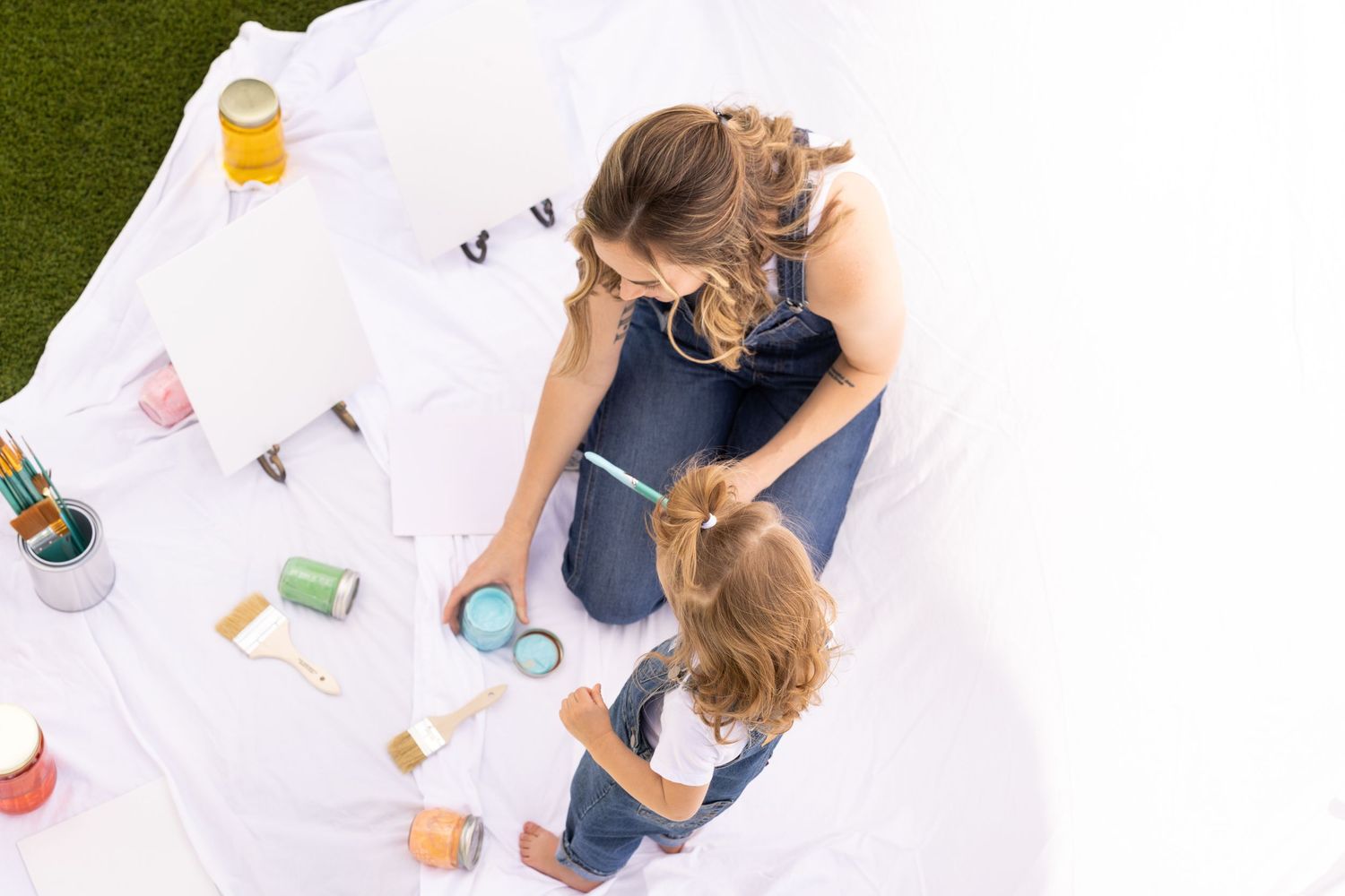 mommy and me painting with yogurt with food coloring as safe paint alternative. family photoshoot session with canvas and white sheet