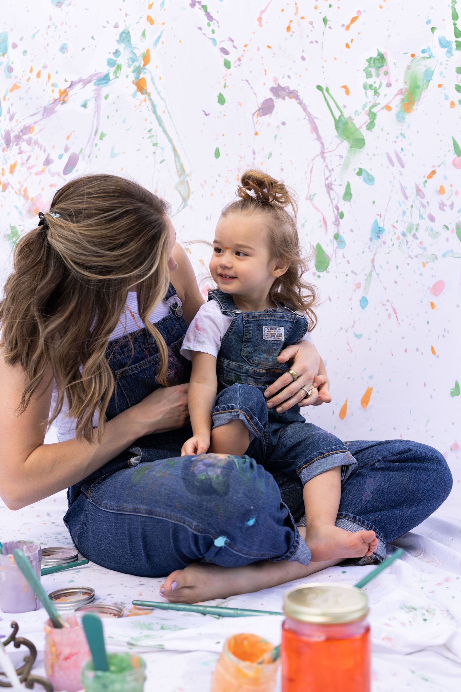 mother daughter photoshoot with splatter paint, white sheets, yogurt with food coloring as paint substitute. non-toxic paint alternative