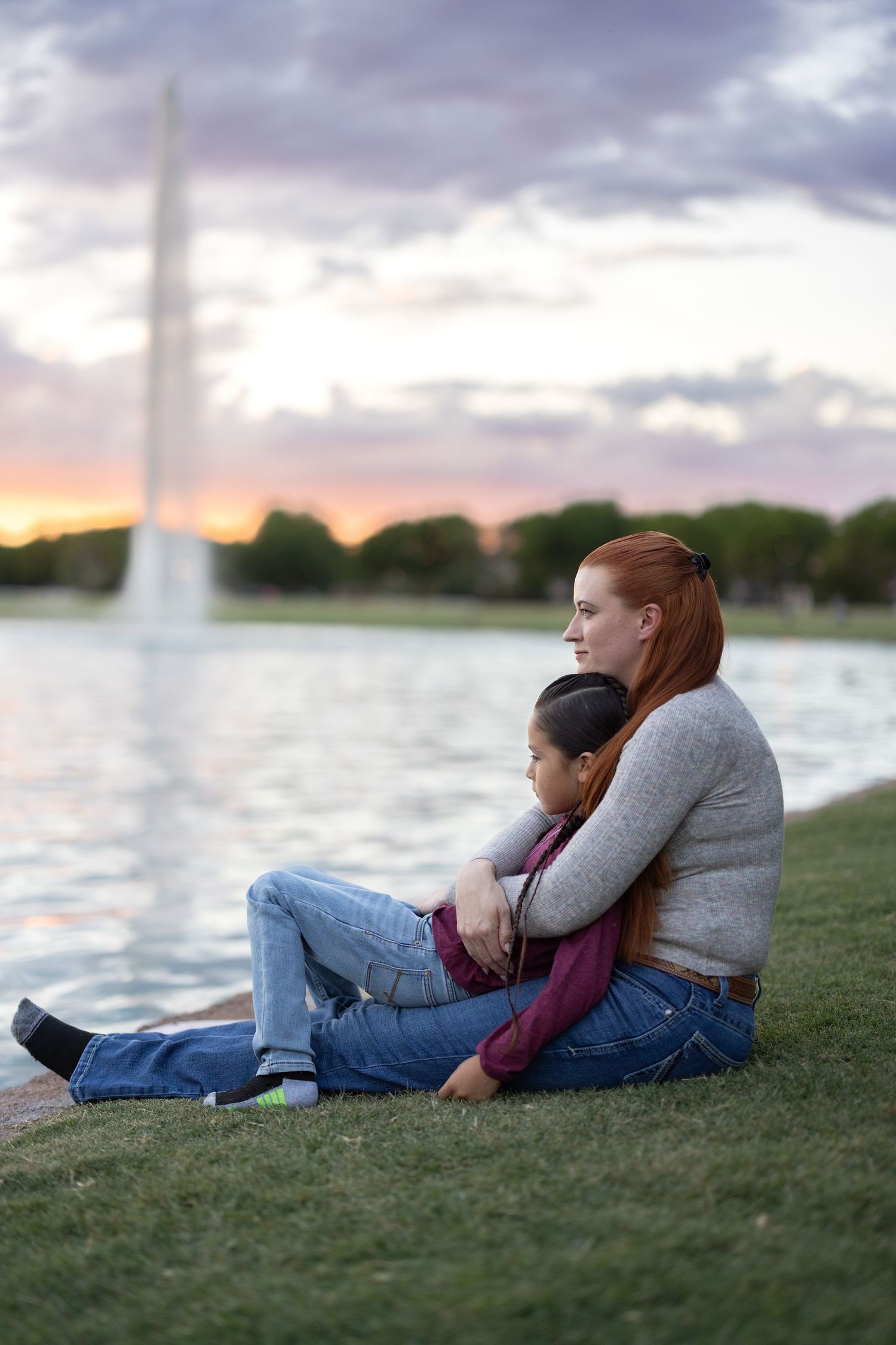 mother holding child at sunset in front of lake fountain, mother son photoshoot session, Morrison ranch, Gilbert, az,