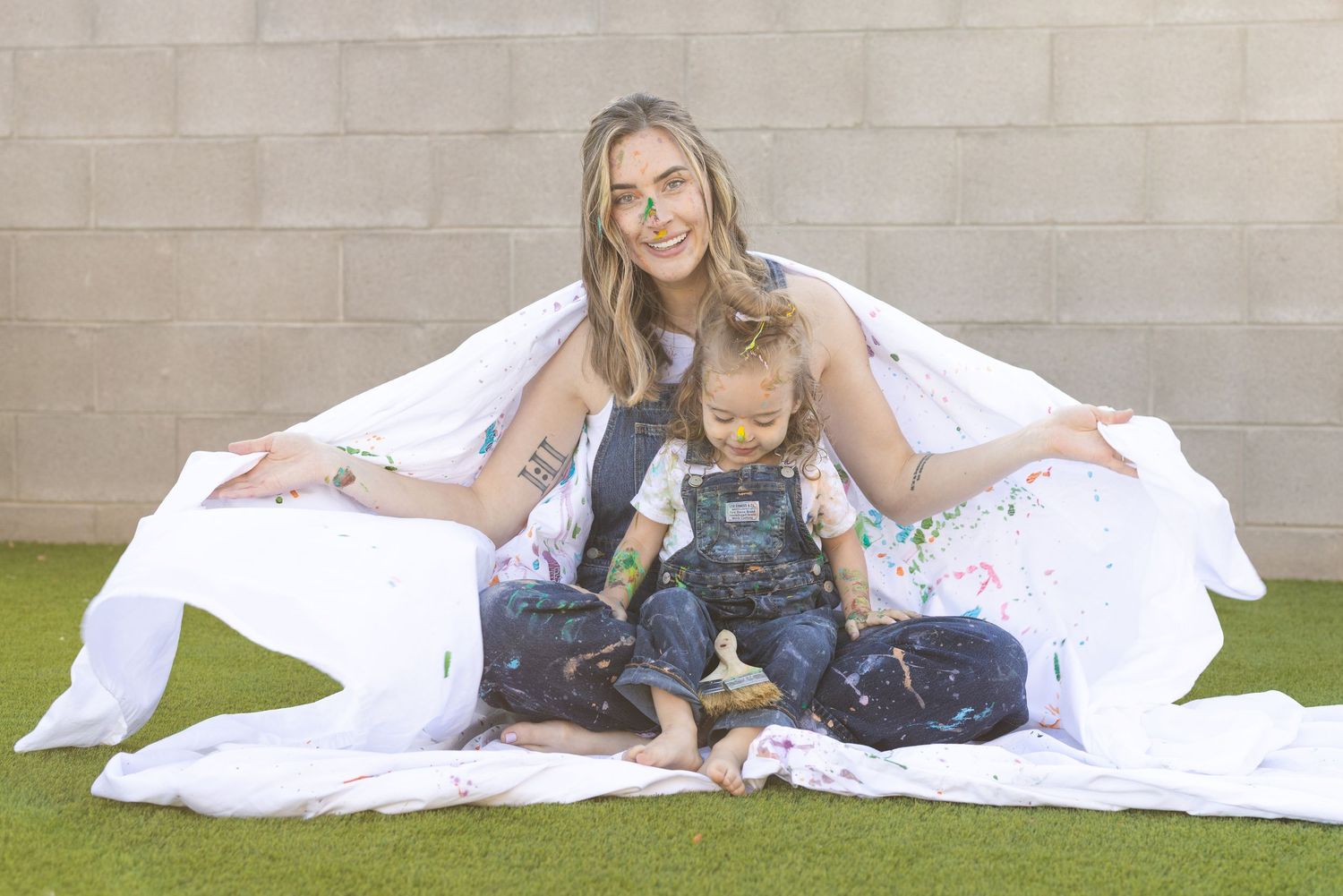 mother daughter in denim overalls during painting family photoshoot mommy and me session. Yogurt alternative to paint, nontoxic eco friendly