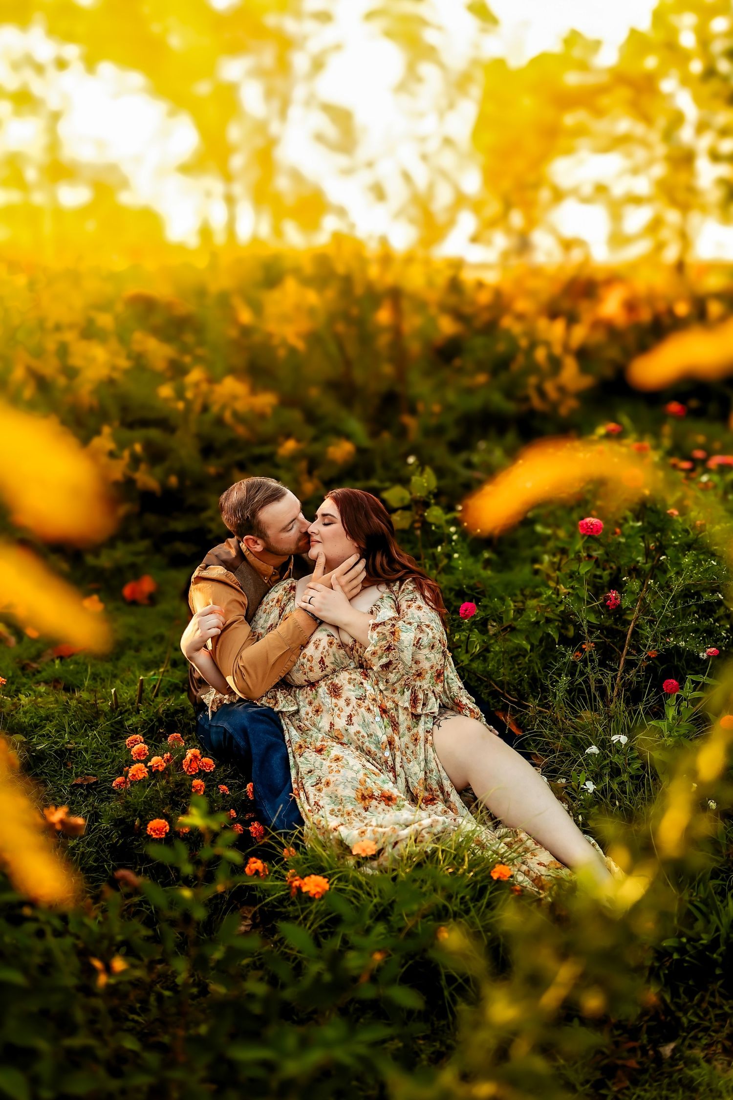 Couple sharing a romantic kiss in a flower garden at golden hour, surrounded by blooming roses and warm sunlight.