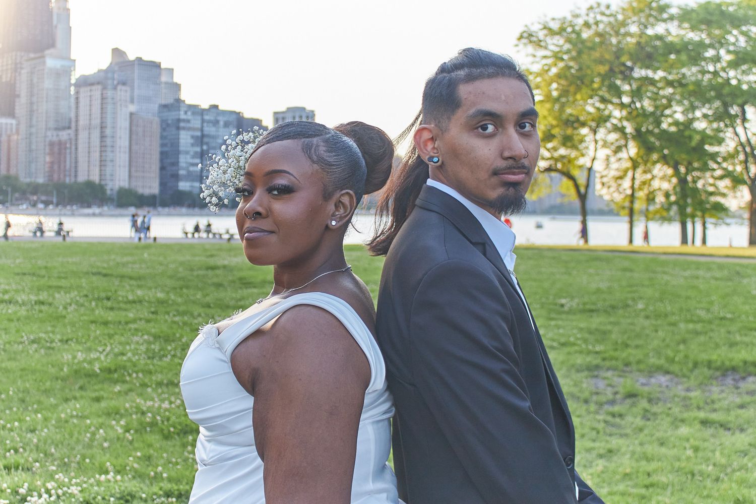 Married couple standing back to back