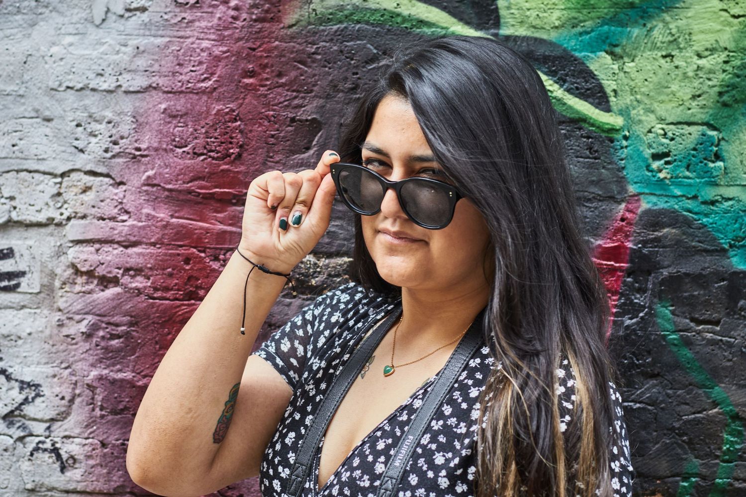 Woman in front of graffiti wall