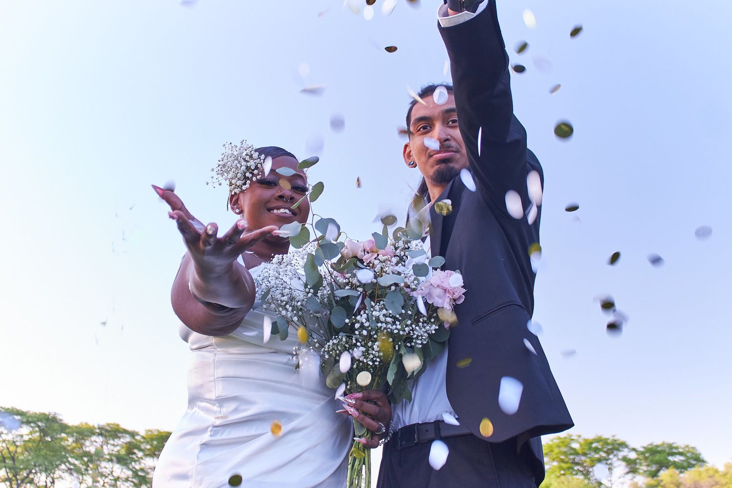 Married couple throwing up flower pedals
