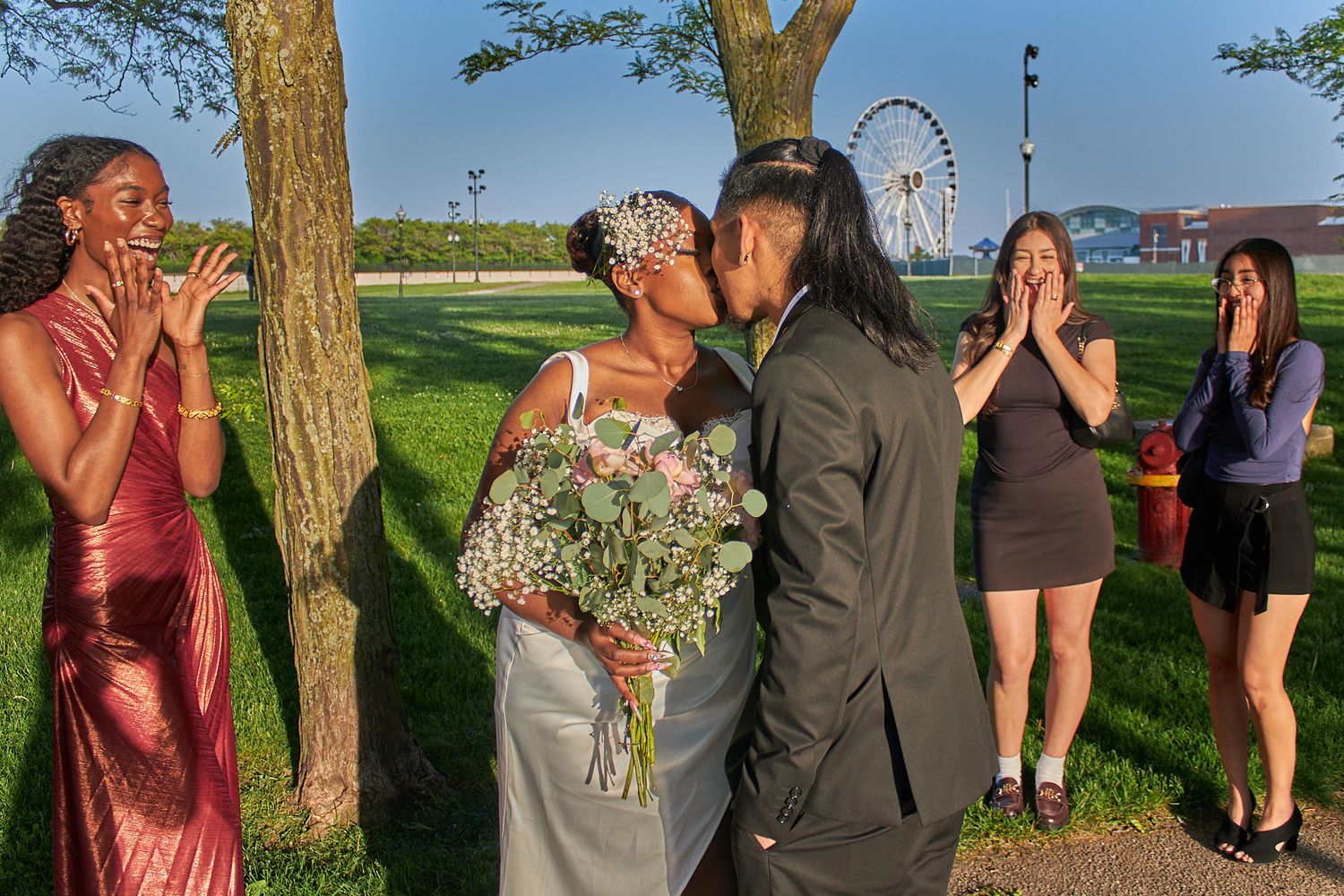Married couple kissing around friends
