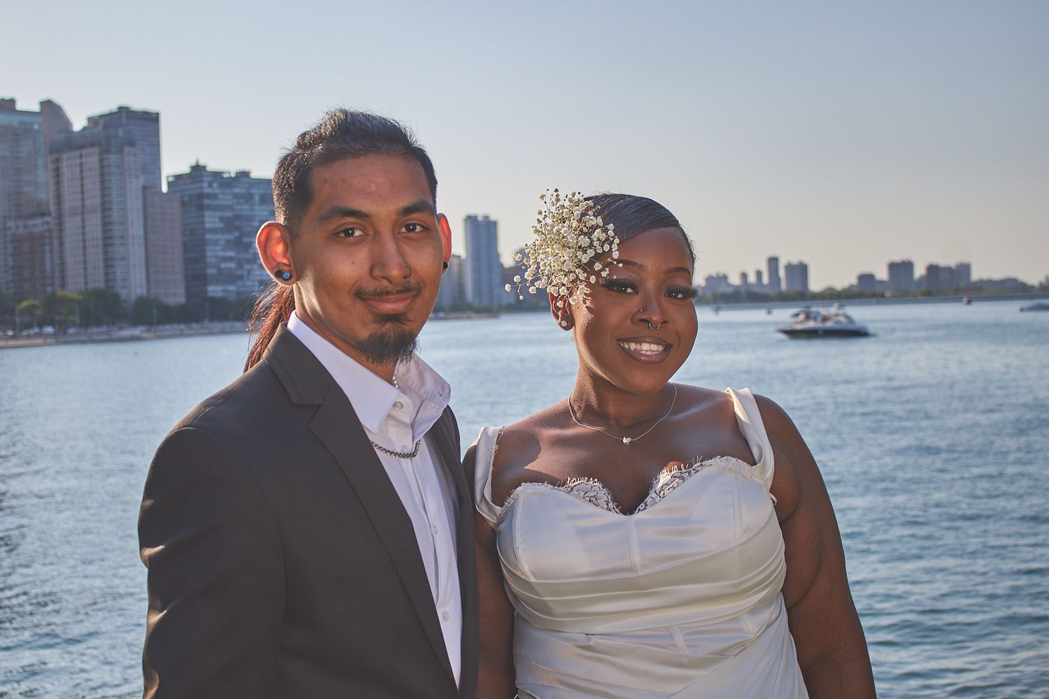 Married couple posed in front of skyline