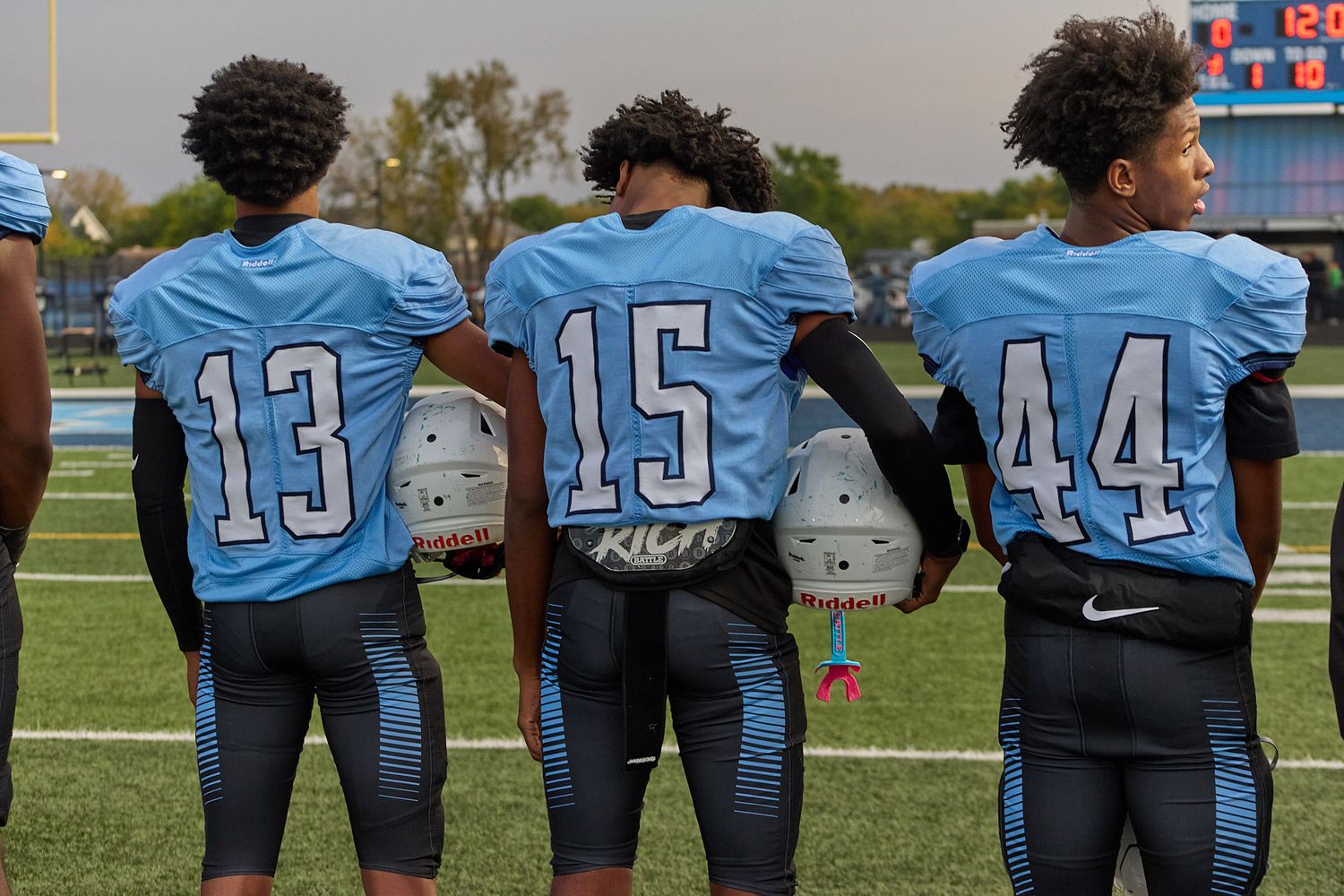 Football players standing for national anthem