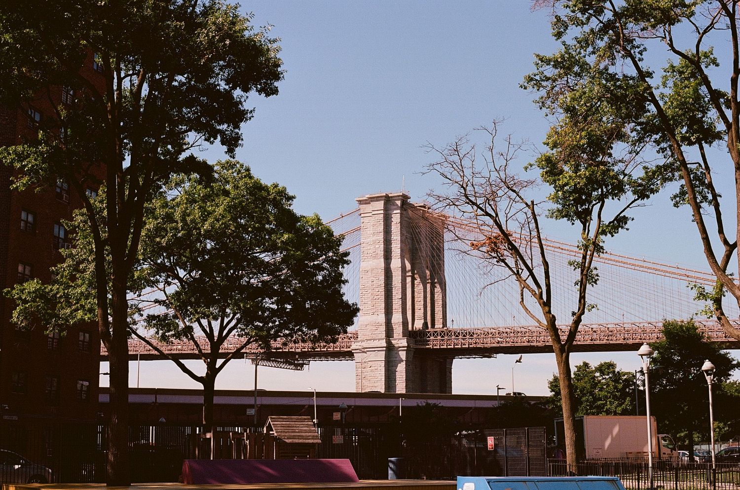 View of the beautiful Brooklyn bridge from a peaceful side street.
