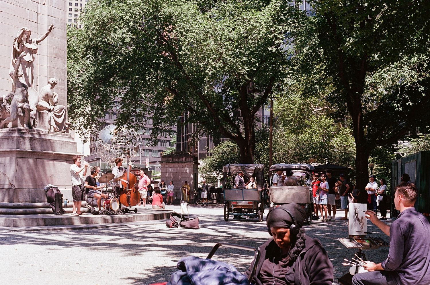 A sunny view of a gathered crowd in central park.