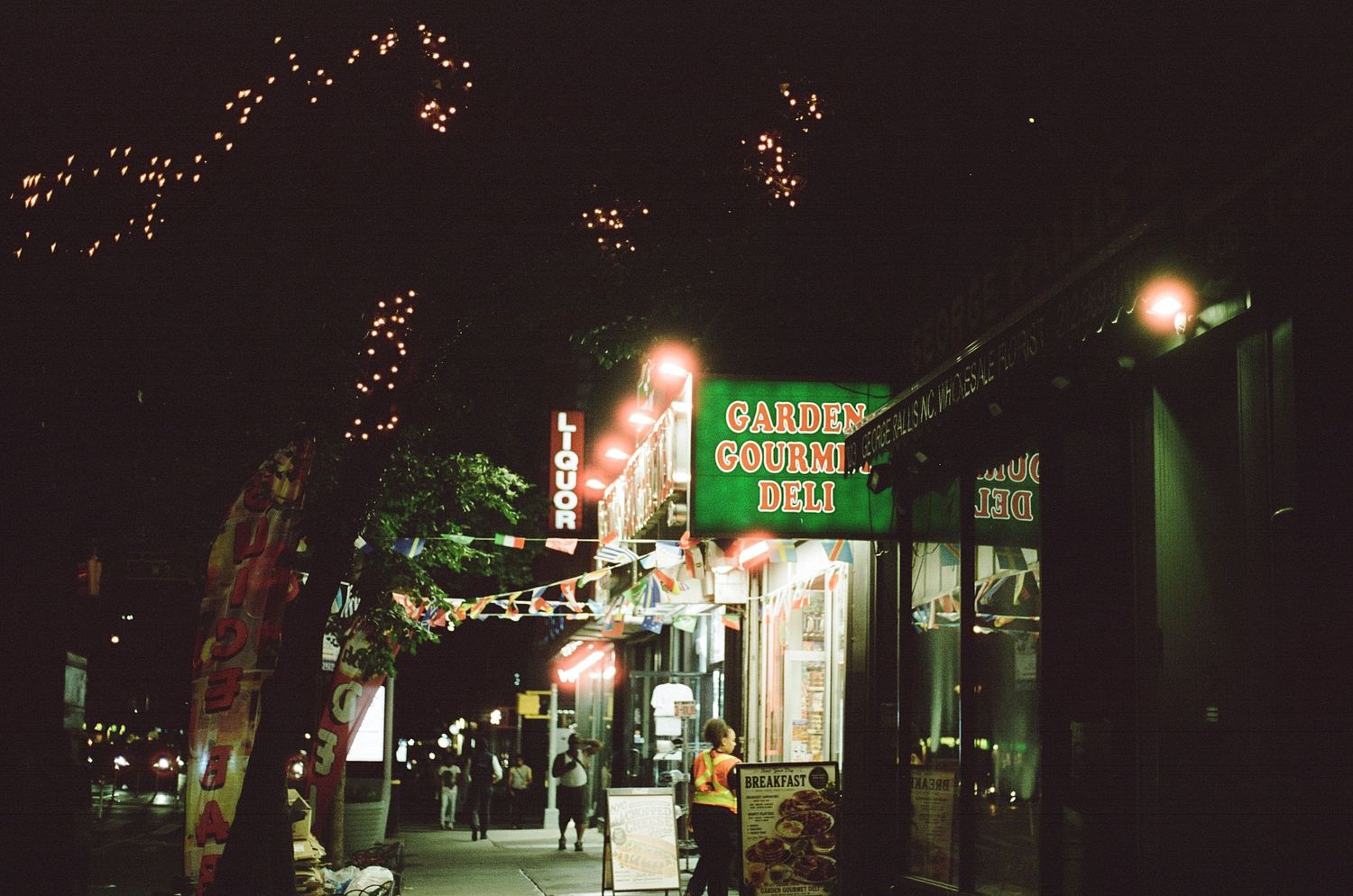 An illuminated convenience store in chelsea, NYC.