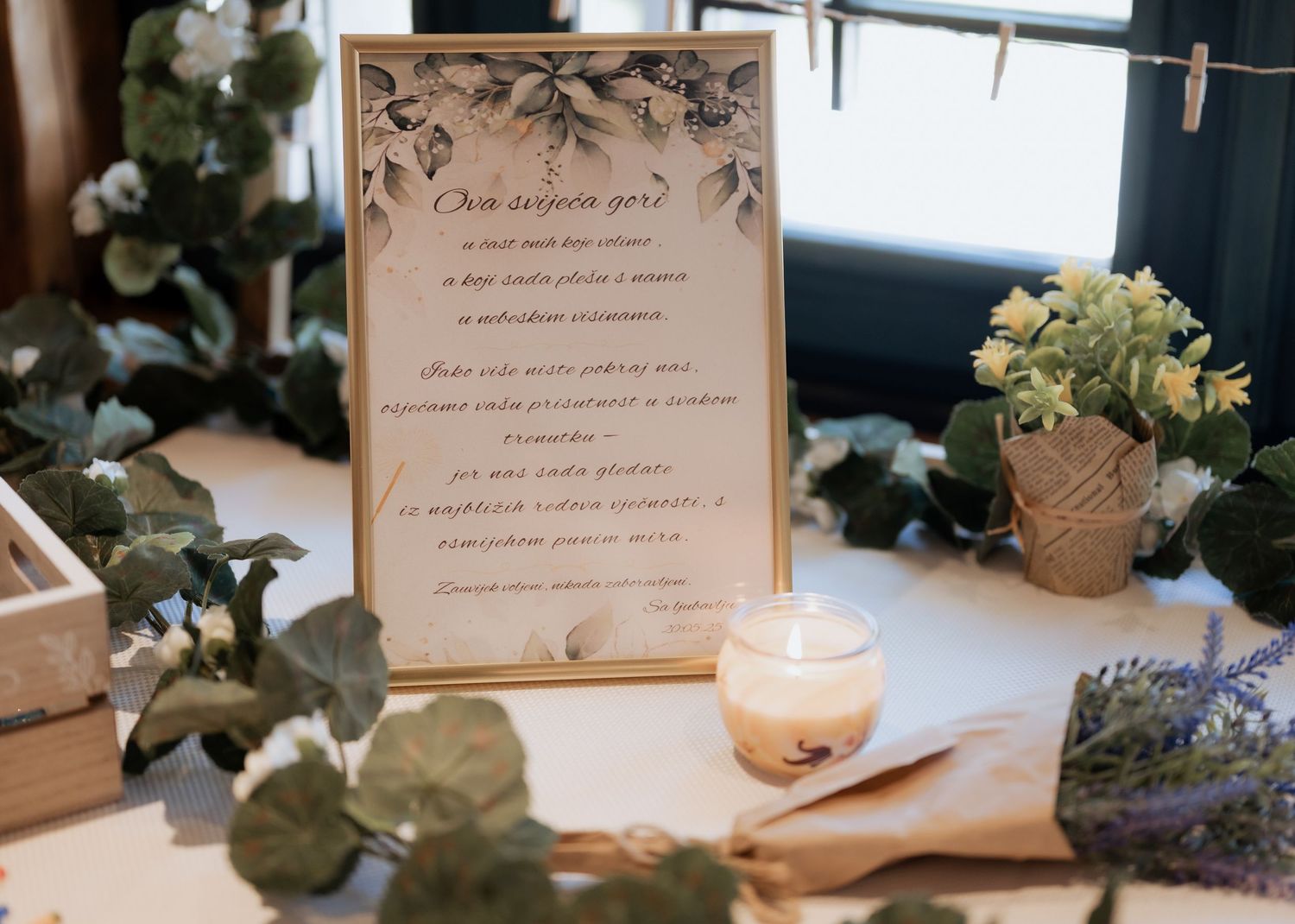 Elegant wedding welcome sign with greenery, candle, and lavender floral decorations on table.