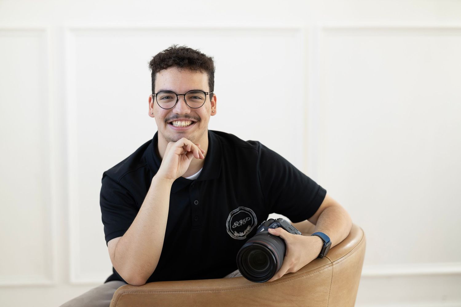 Esteban Gonzalez professional photographer from Dallas Texas posing with camera.