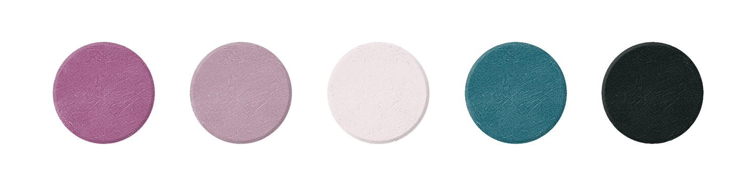 Five matte eyeshadow pans in purple, mauve, blush pink, teal, and charcoal shades arranged in a row.