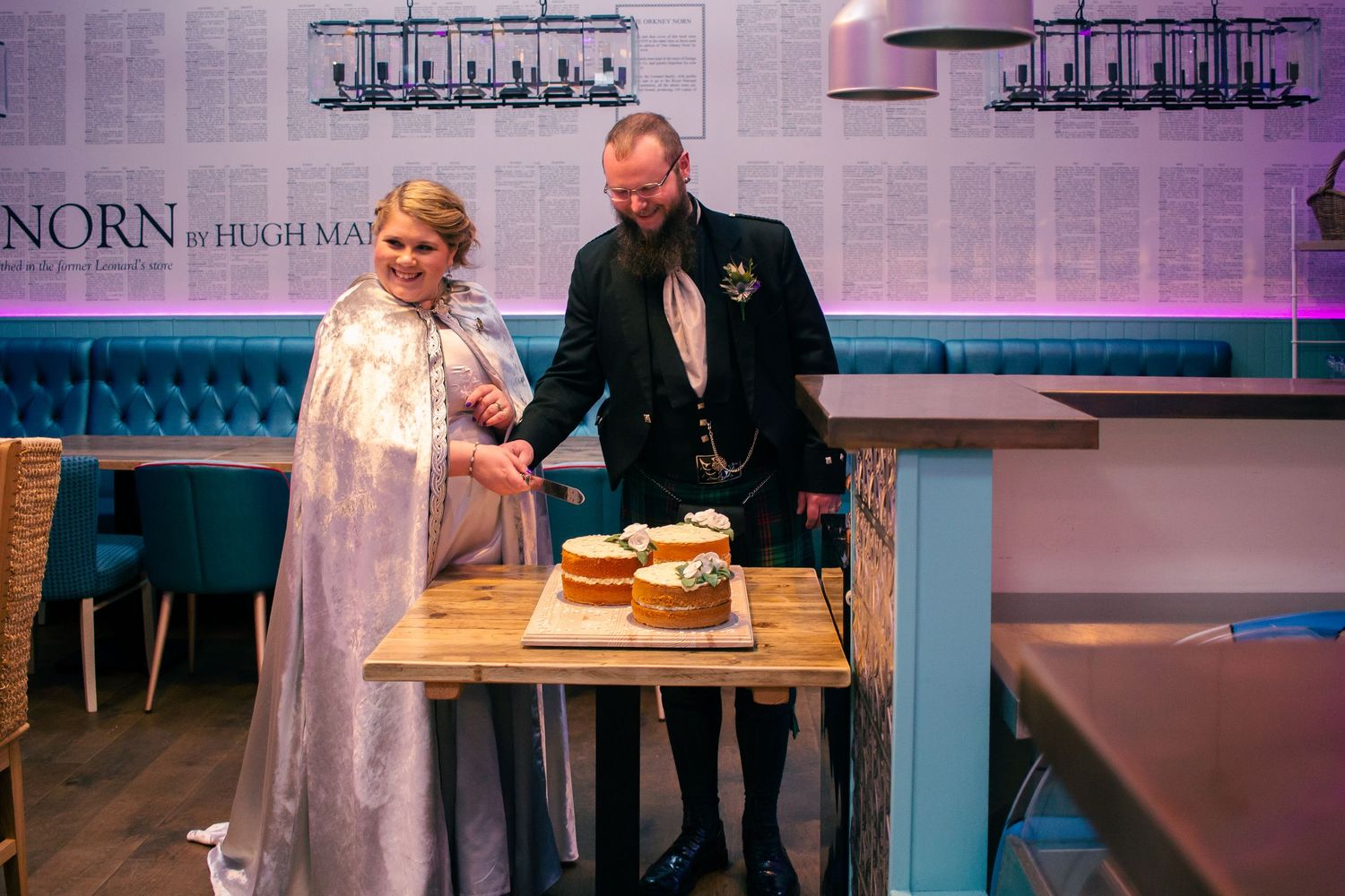 Couple in formal attire cutting a cake at the storehouse, kirkwall.