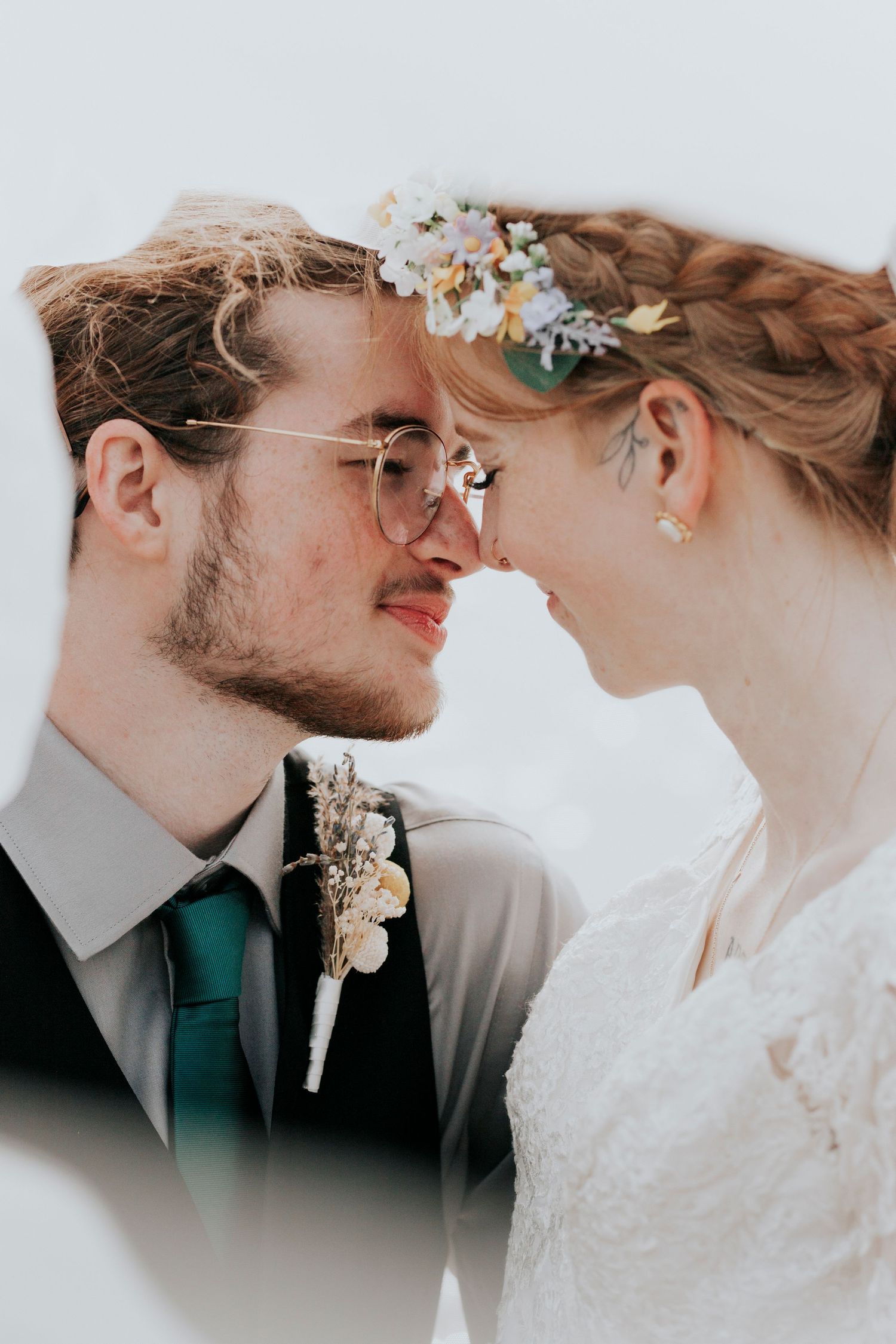Close up wedding portrait of a romantic couple under the veil of the bride.