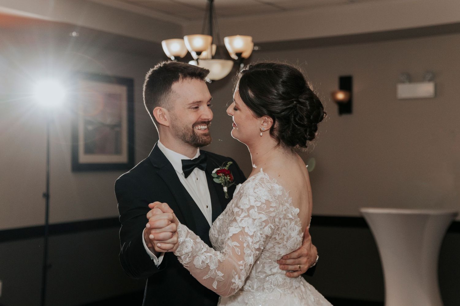 Bride and groom share their first dance together at elegant wedding reception venue.