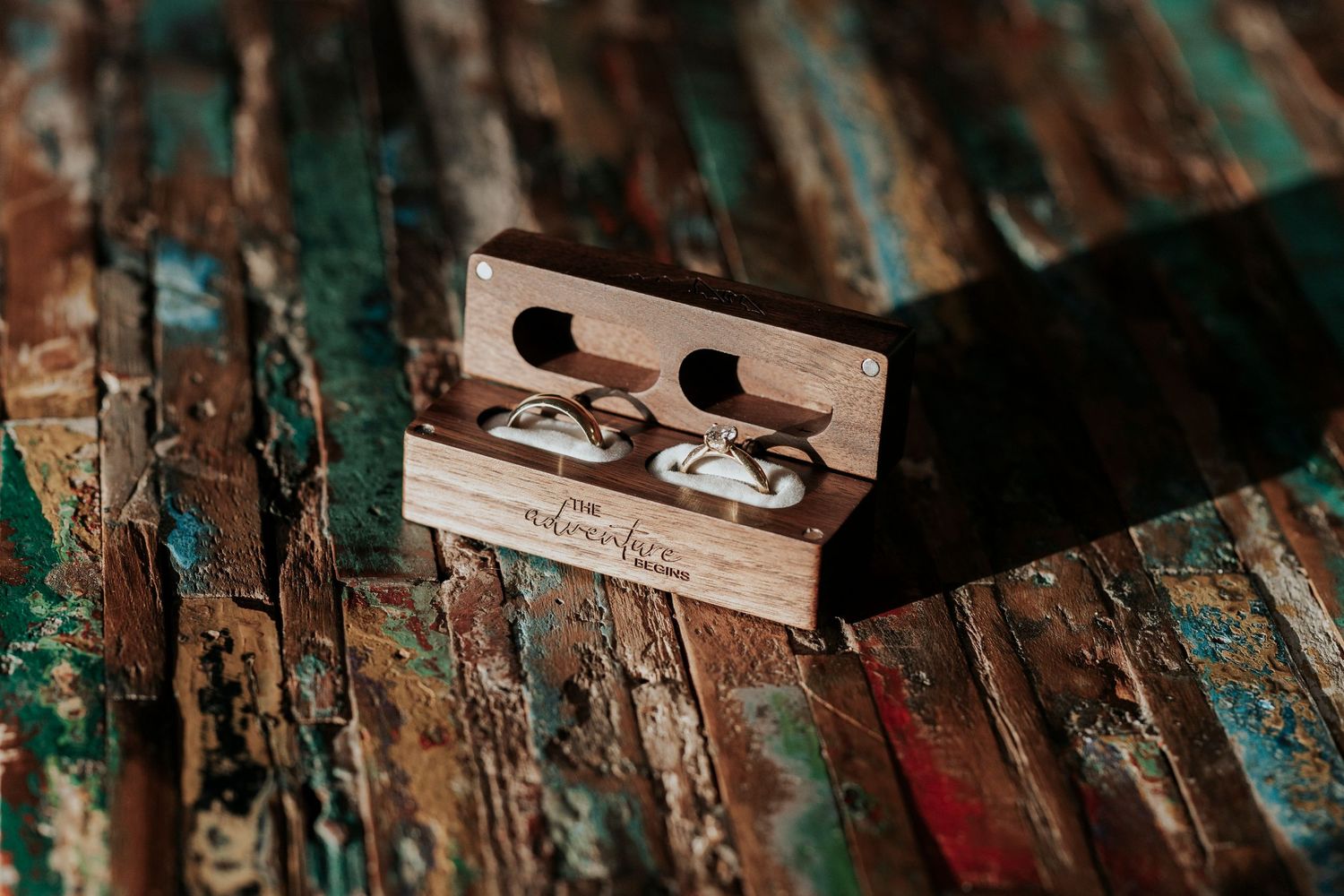 Rustic razor blade on weathered turquoise painted wooden surface in macro photography.