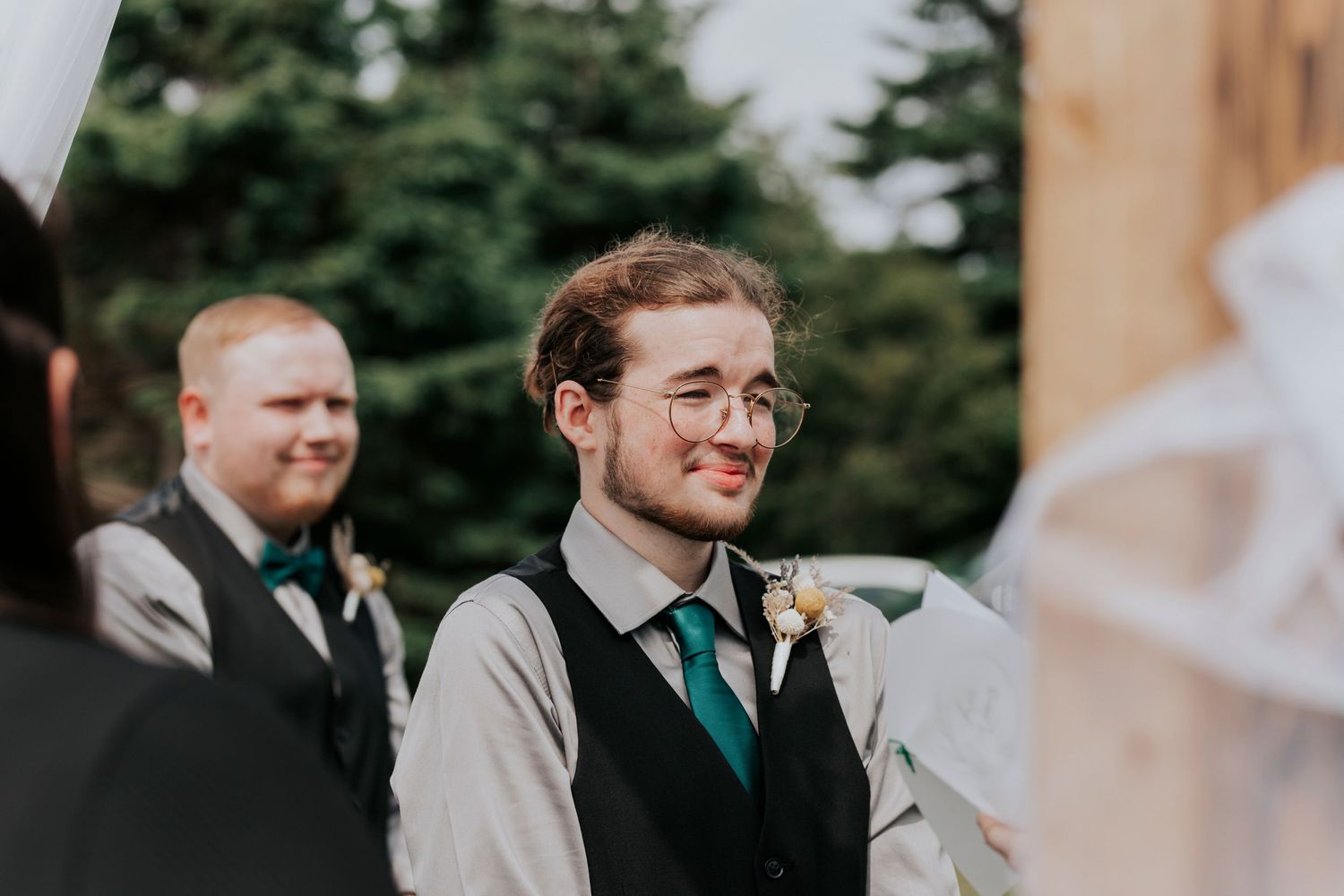 Groom listens and reacts with pure emotion to his brides vows.