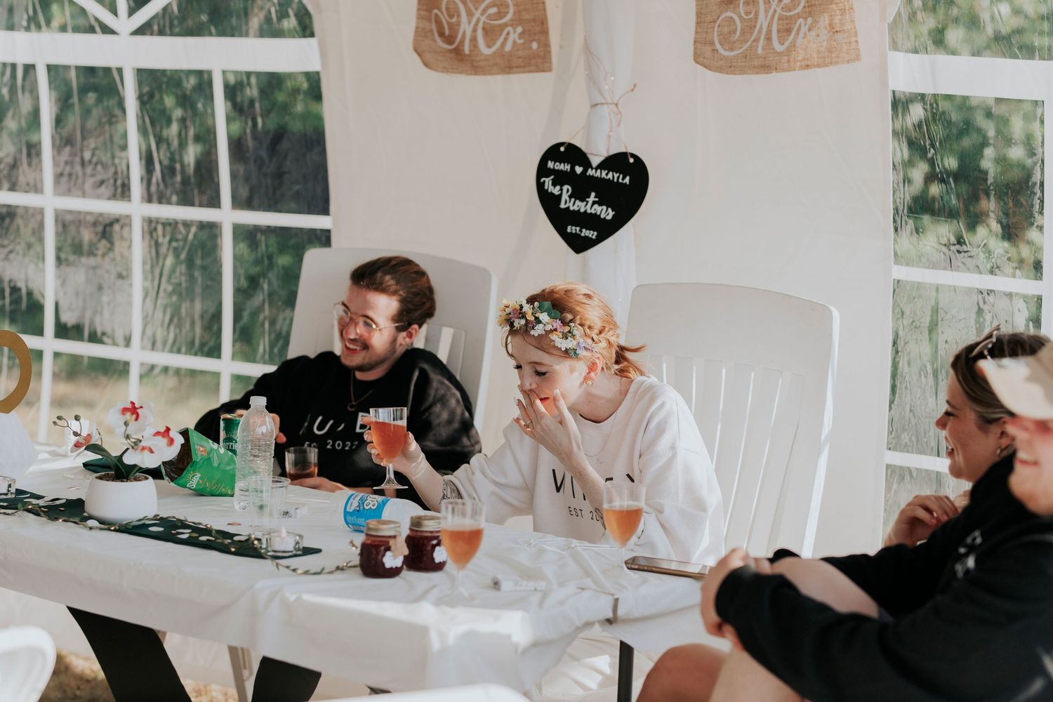 Newlyweds listen to speeches from their family on their wedding day.