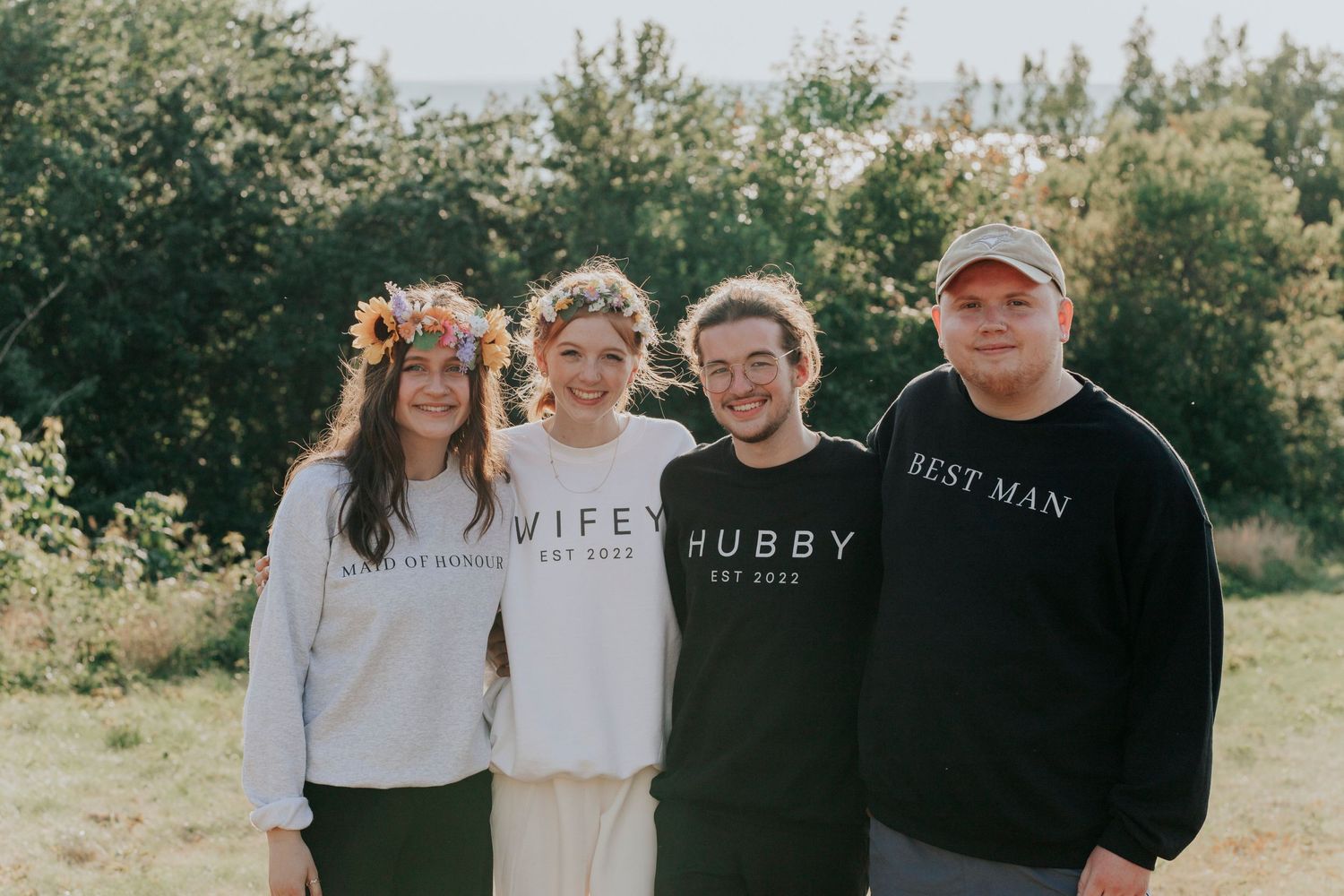 The bridal party smile with their matching sweaters during a cape Breton wedding