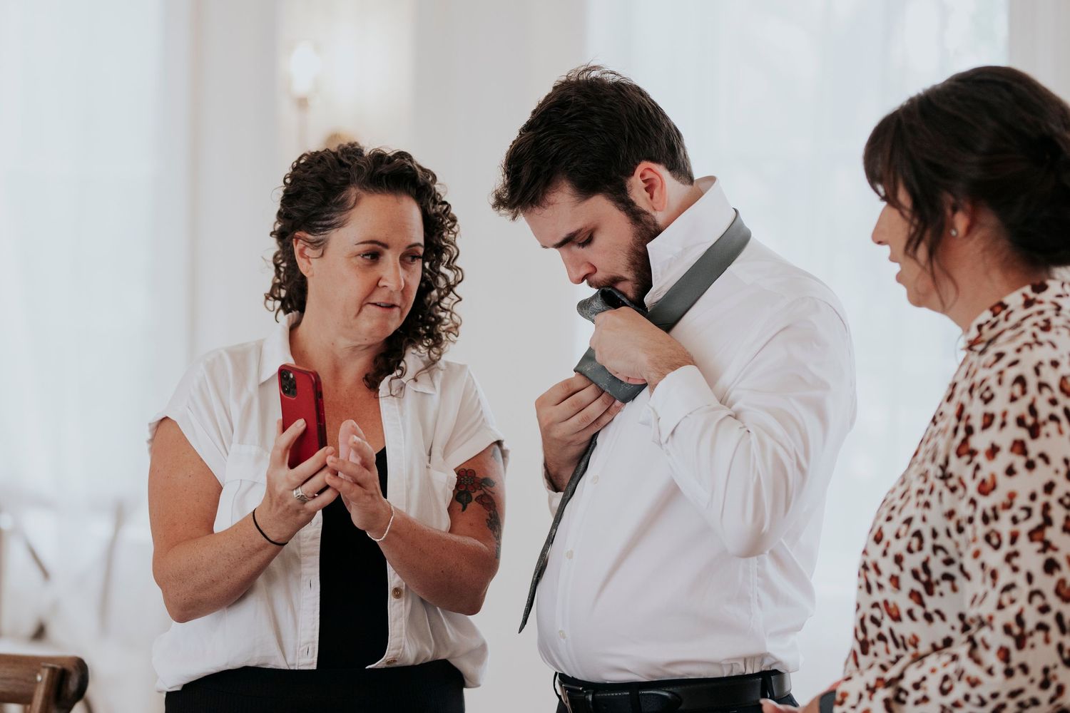 The grooms family watches a video on how to tie a tie before the ceremony