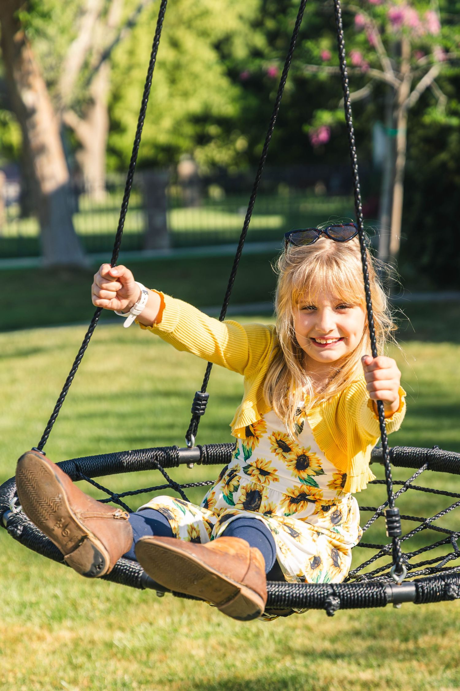 Young girl smiling on playground swing