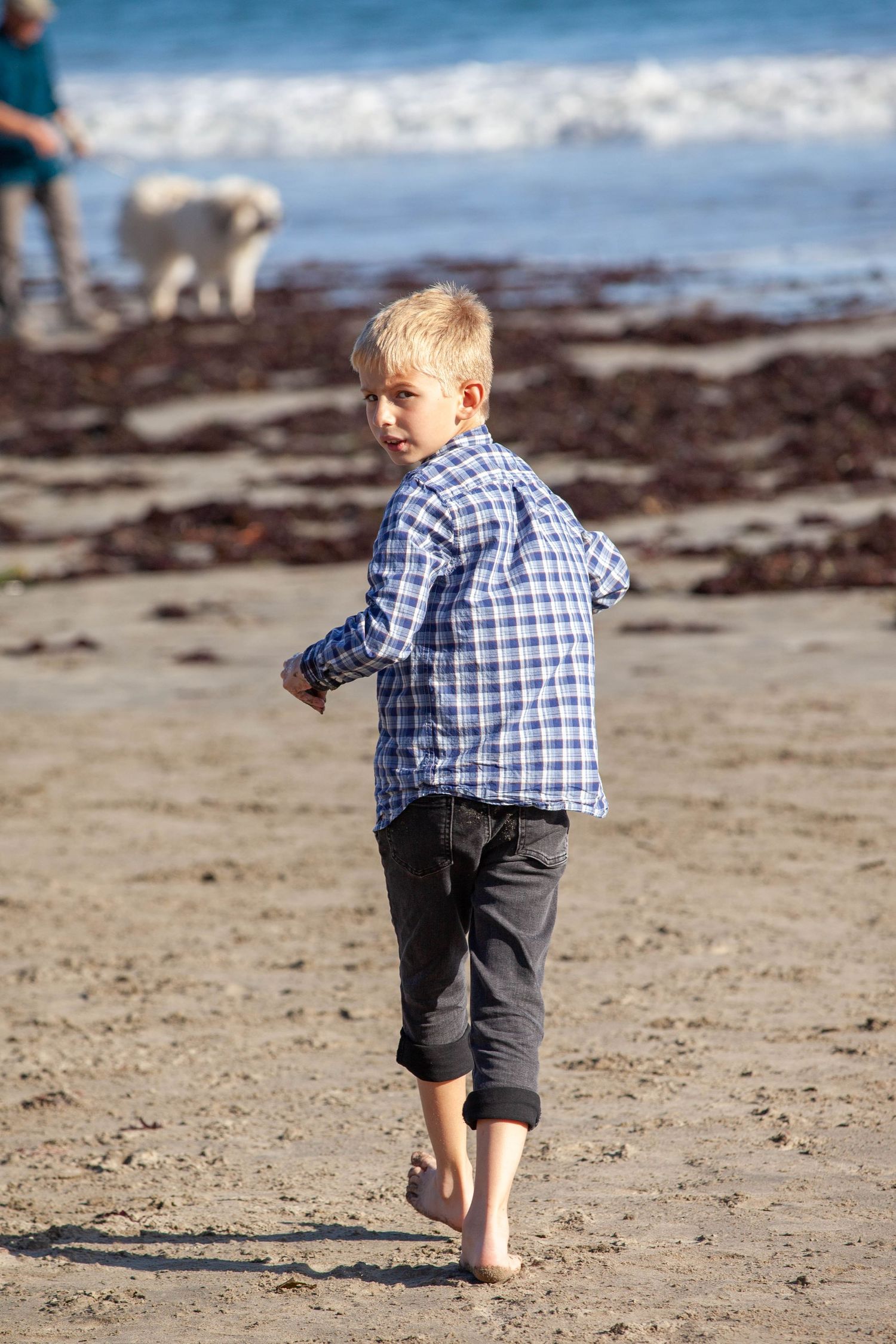 Young boy running on the beach