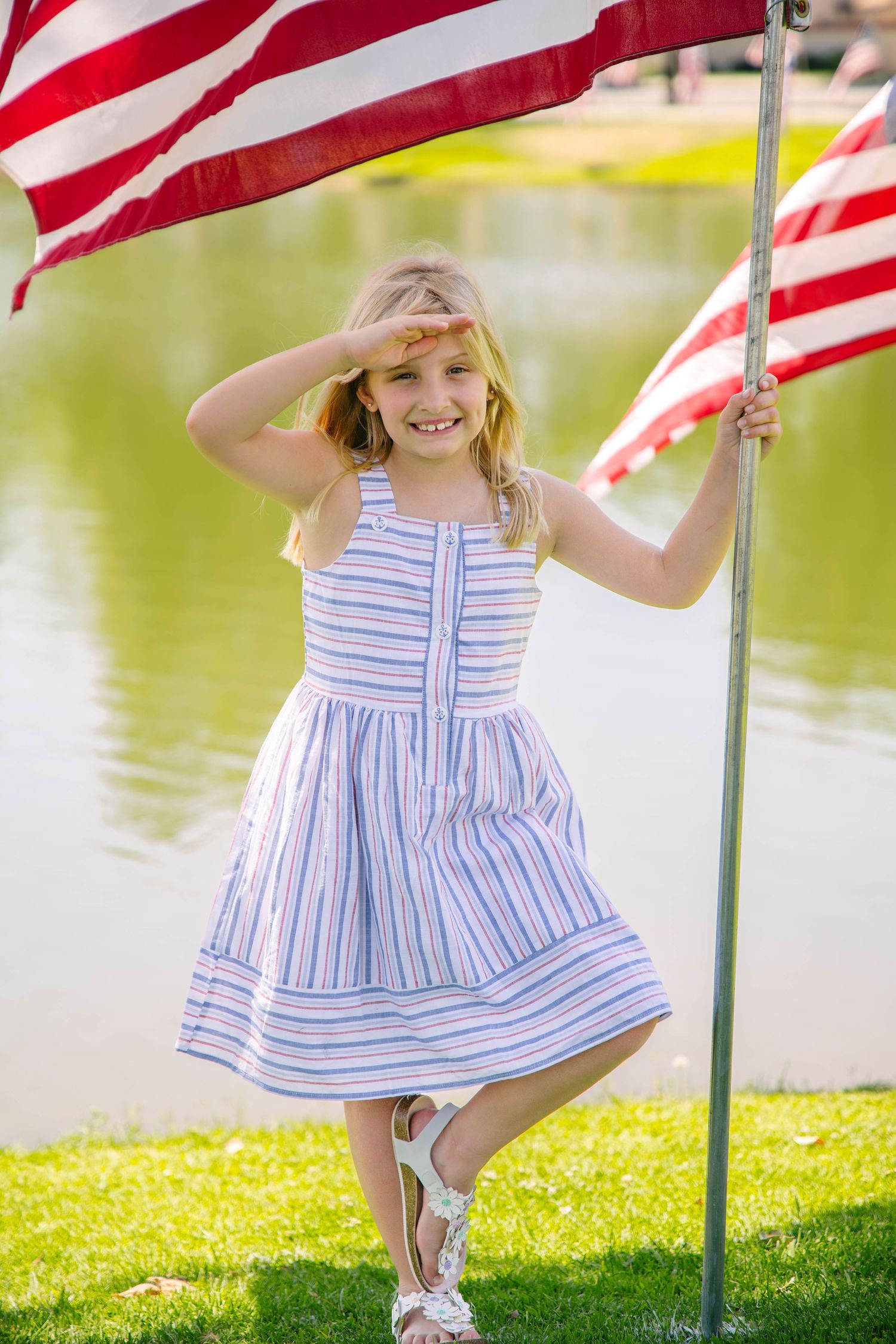 Young girl saluting the American flag