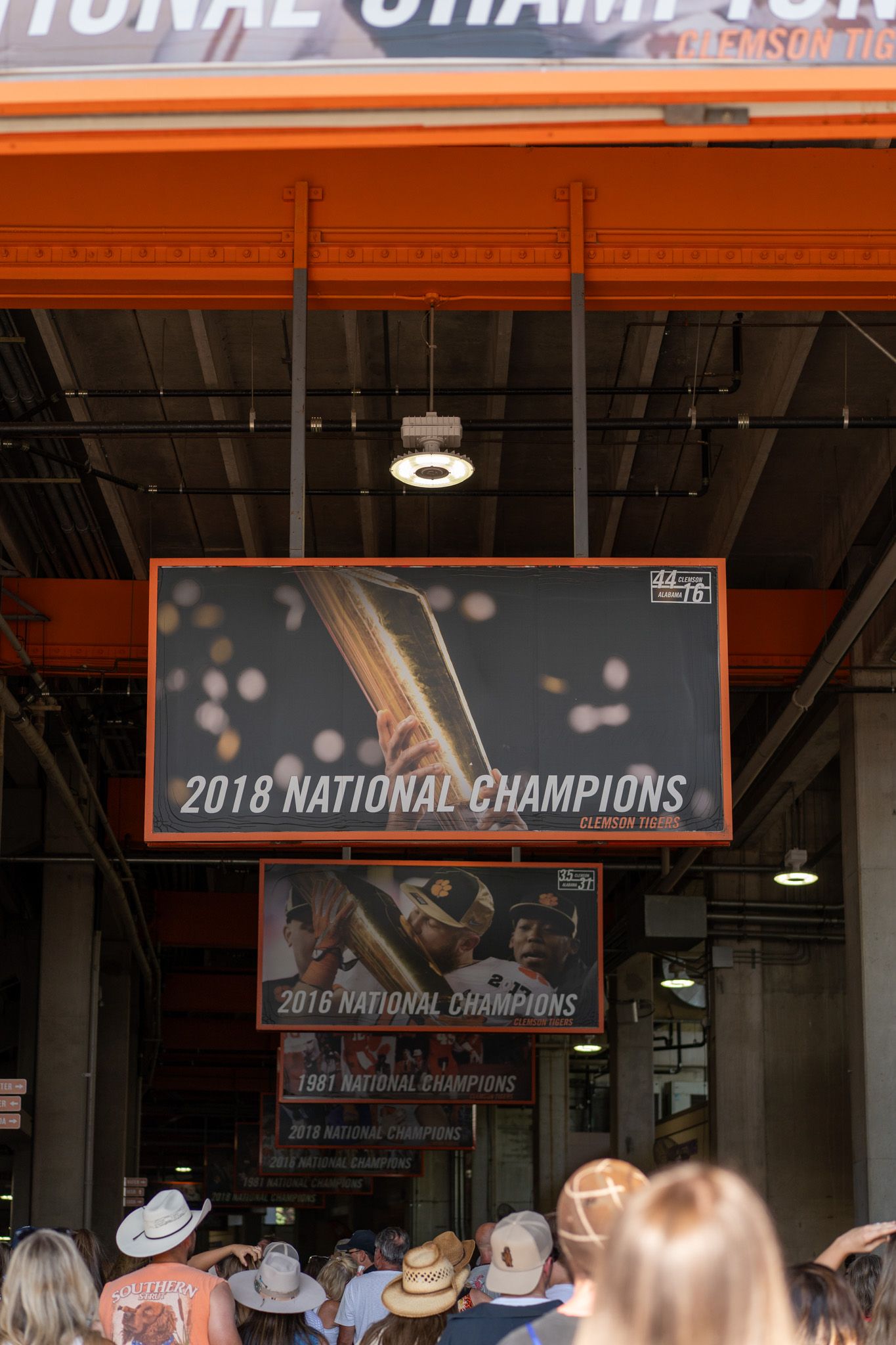 Clemson Tigers 2018 National Champions banner displayed at stadium entrance with crowd gathered below.