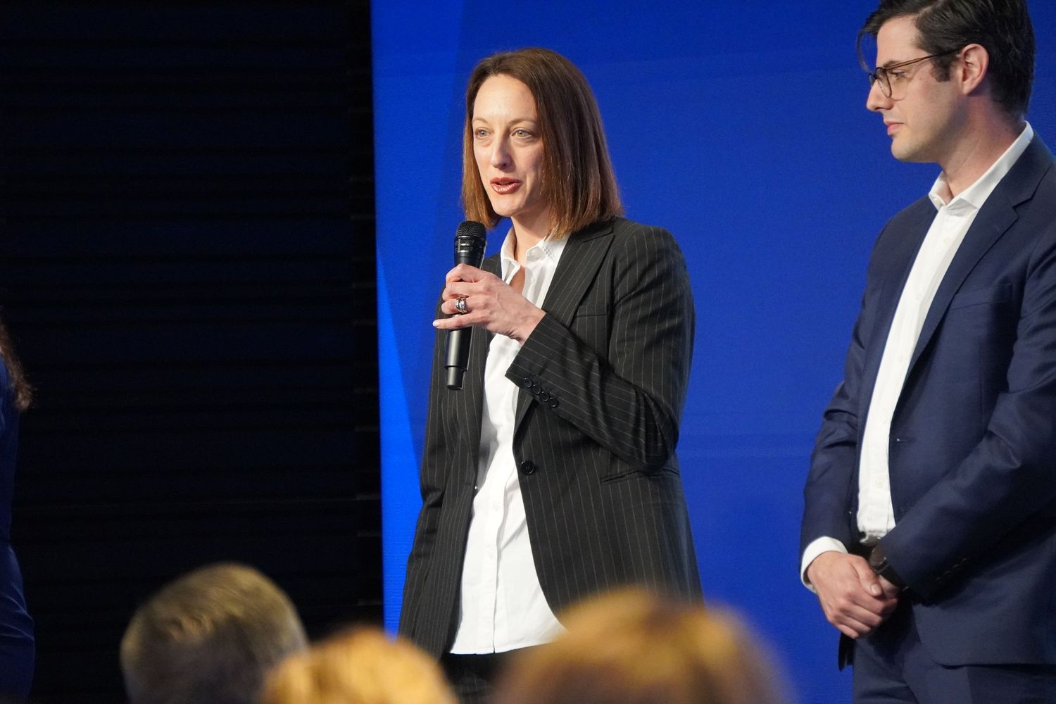 Documentary photo of a woman speaking on stage at a Sydney business event.