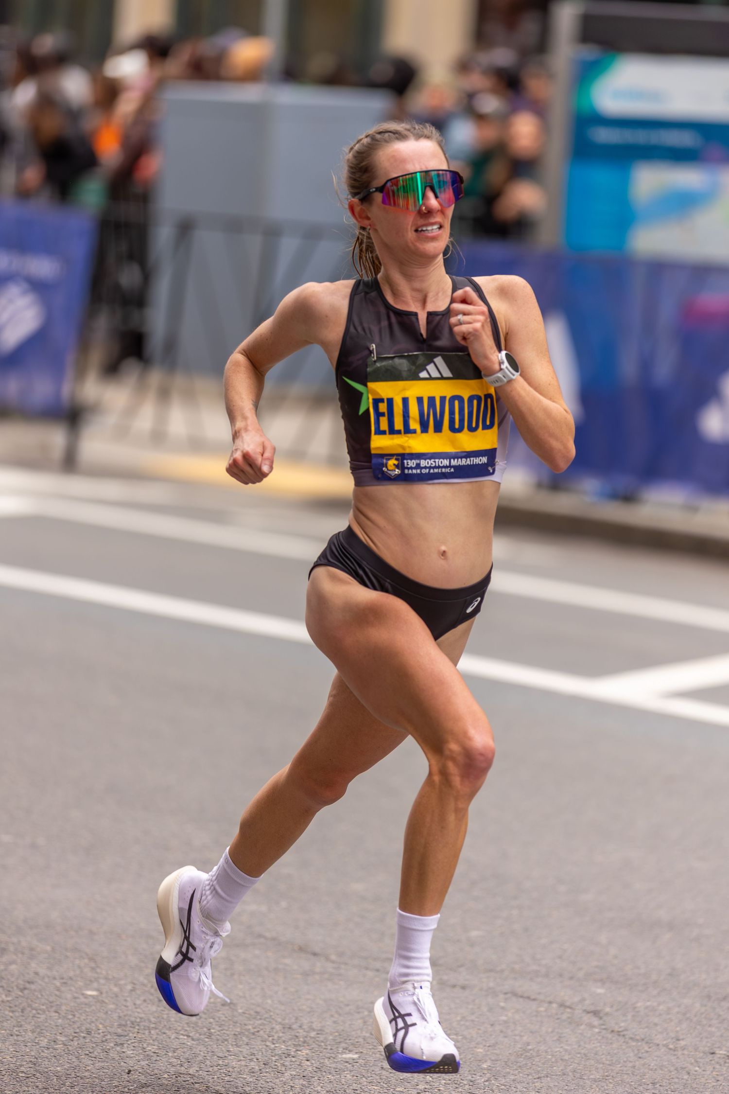 Runner Ellwood competes in the Boston Marathon wearing Adidas gear and sunglasses.