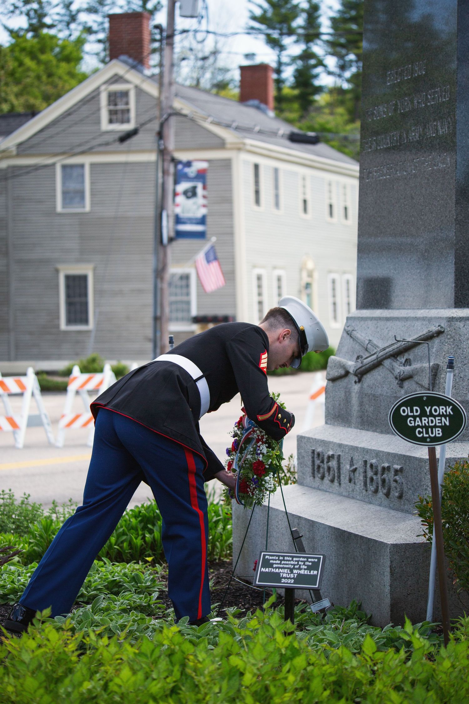 Marine in dress uniform lays a wreath at a Civil War memorial monument for the Old York Garden Club ceremony.