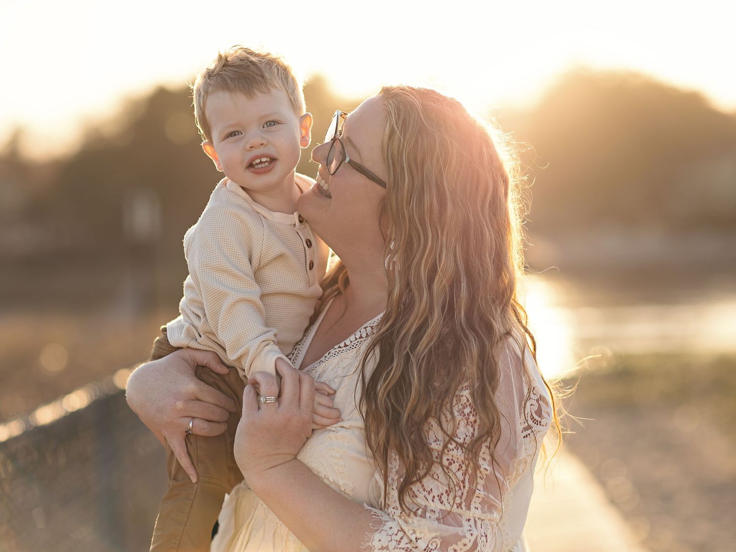 Candid family moments captured during sunset beach photography session.