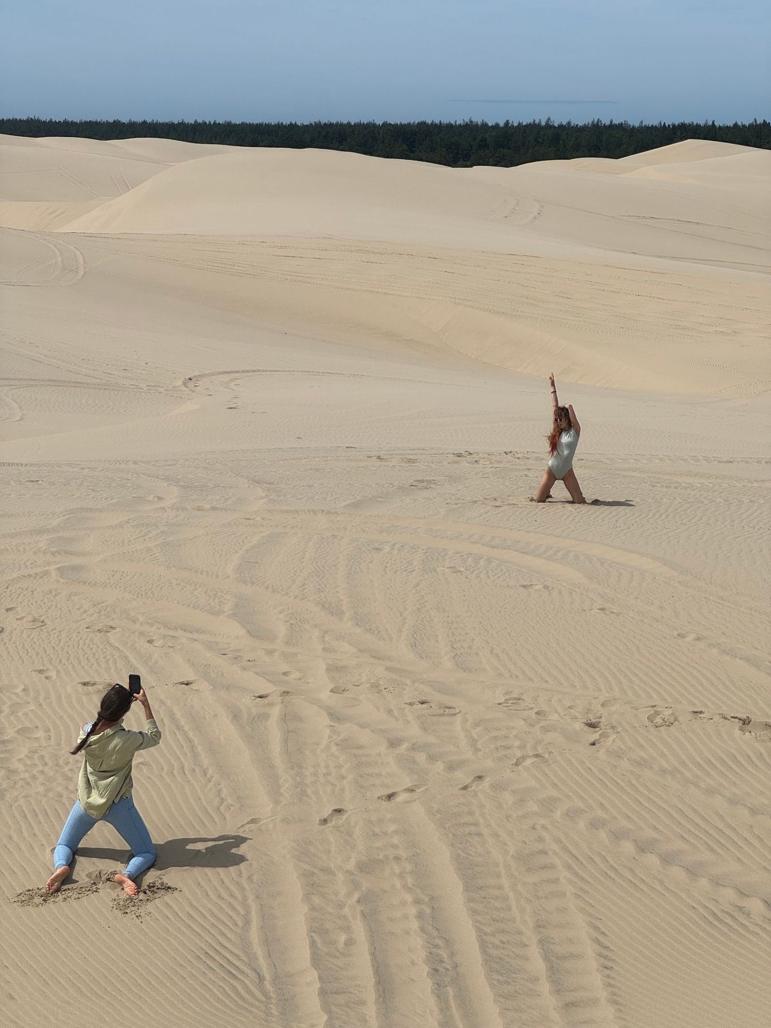 Seattle photographer photographing a woman during a portrait session at the Oregon sand dunes