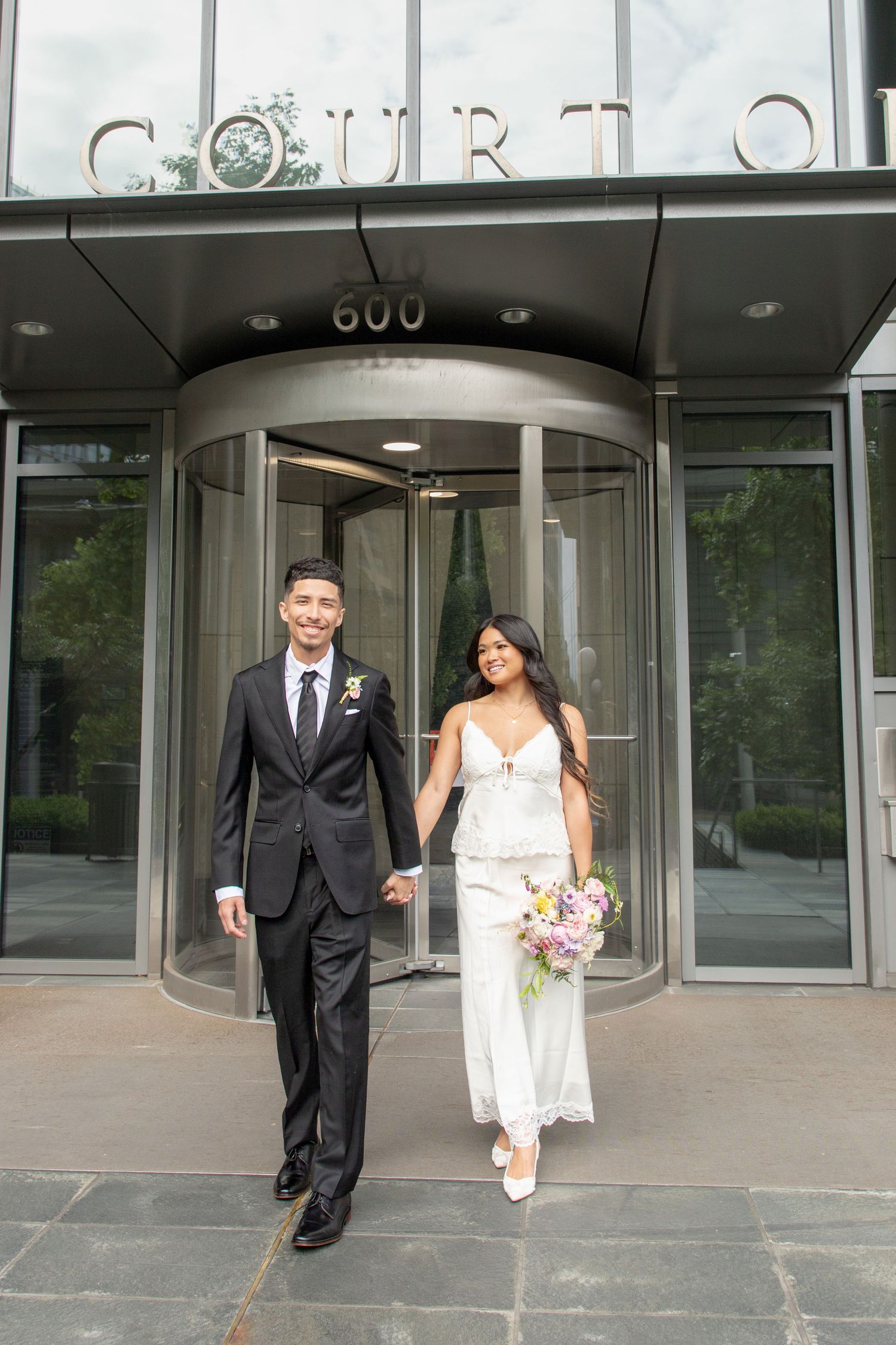 Newlywed couple leaving the Seattle Justice Center after their courthouse wedding