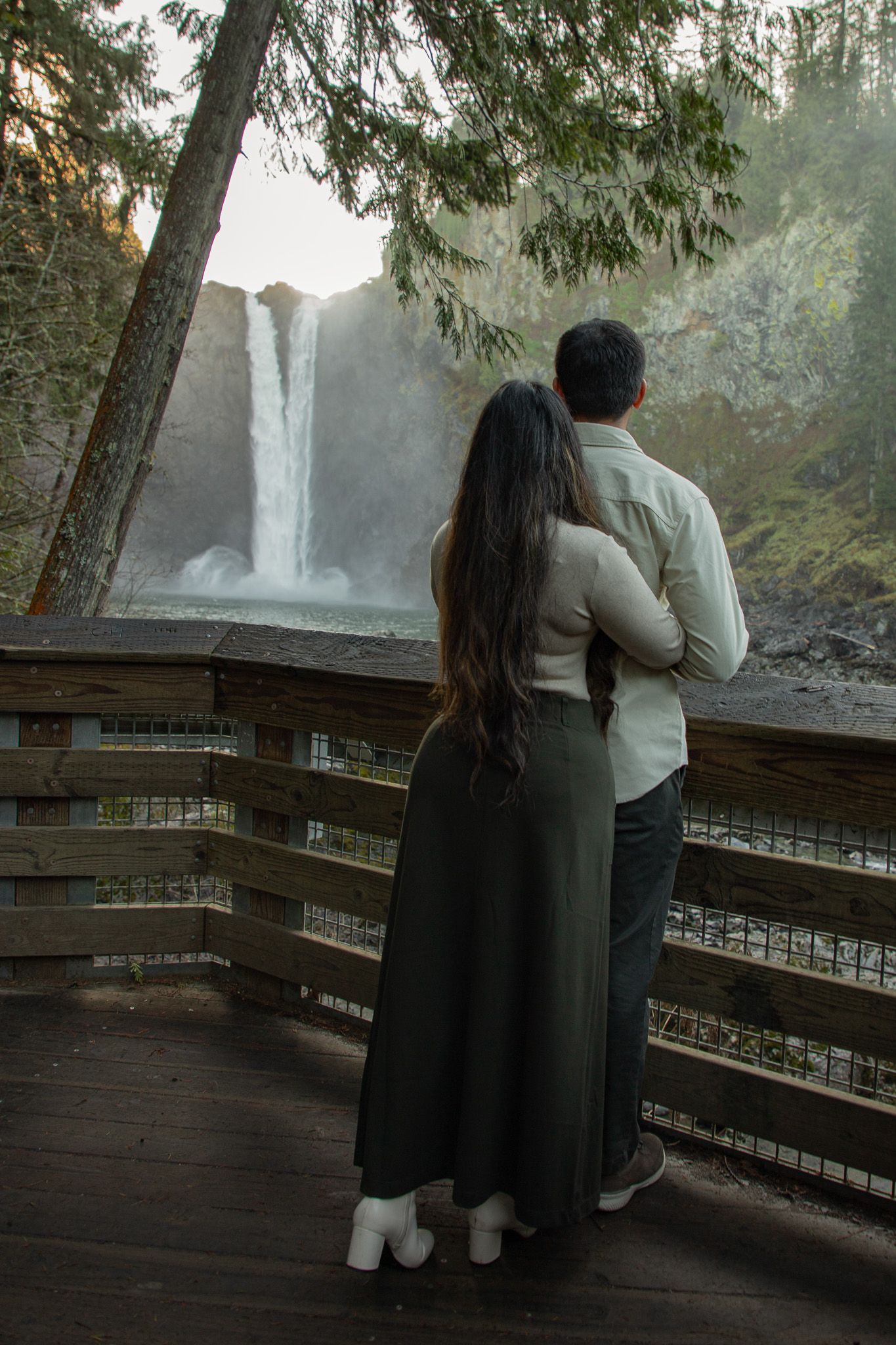 Seattle engagement photographer capturing a couple during an adventurous Snoqualmie Falls engagement photoshoot near the waterfall lookout