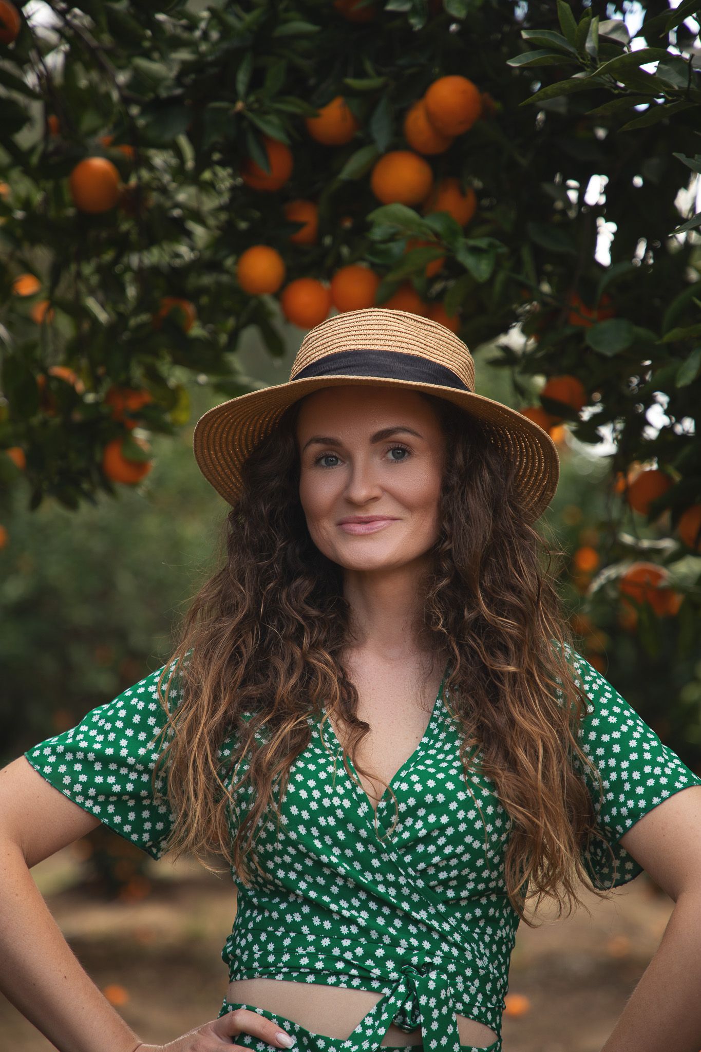 Seattle portrait photographer photographing a woman in blooming orange blossoms during a spring photoshoot