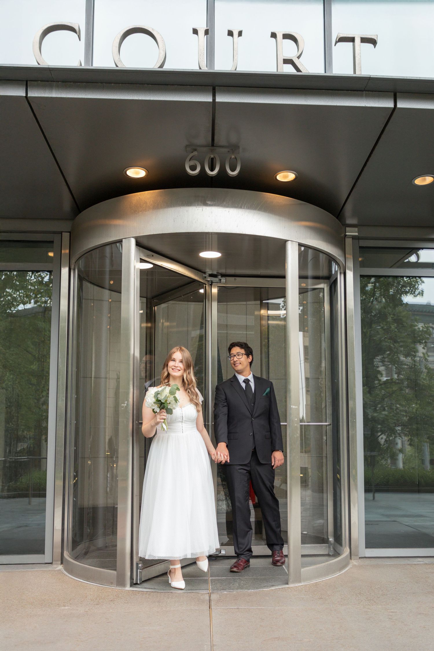 Newlywed couple leaving the Seattle Justice Center after their courthouse wedding ceremony