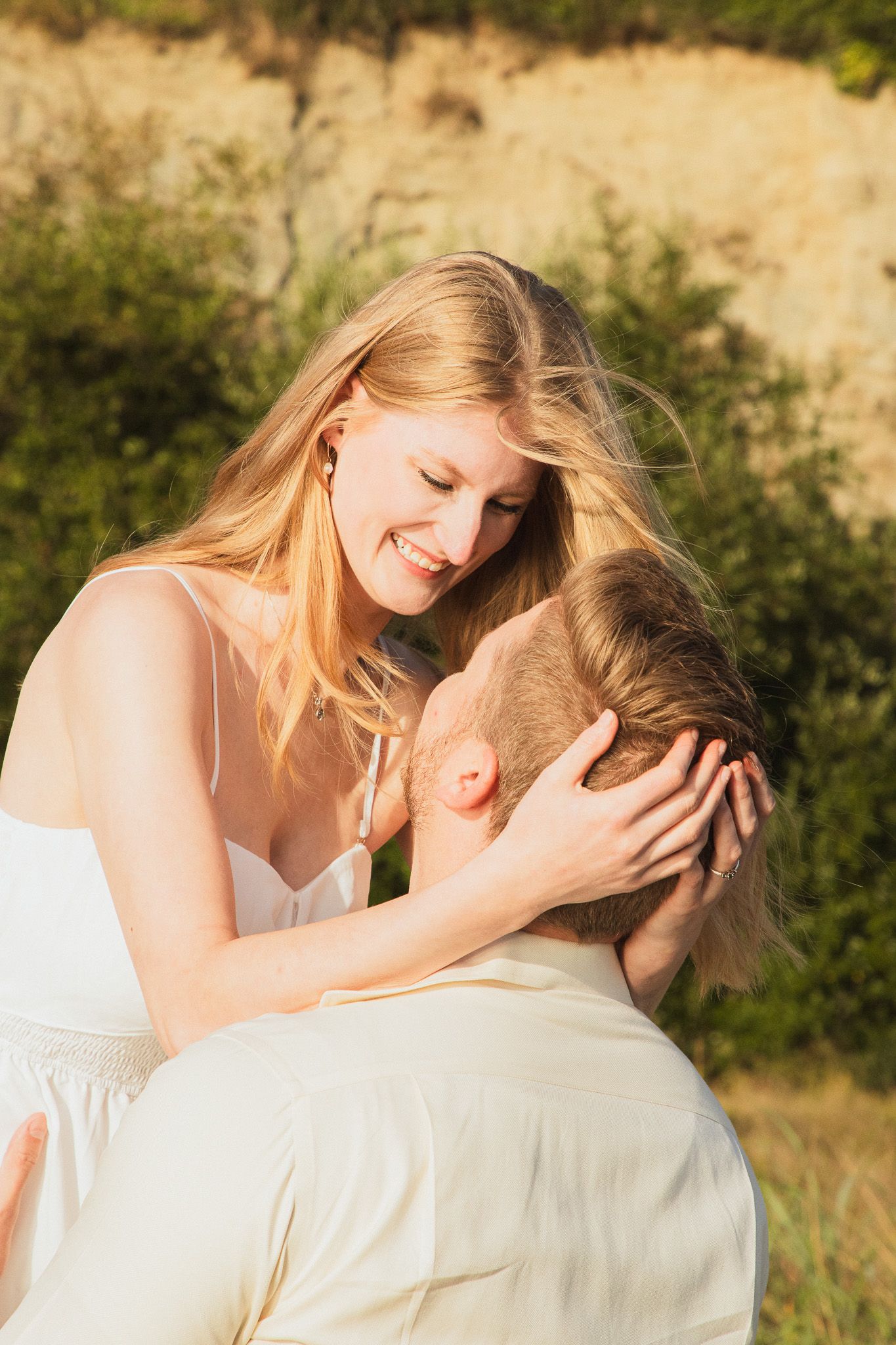Discovery Park couple photoshoot at sunset, Seattle photographer capturing warm golden light and Puget Sound scenery