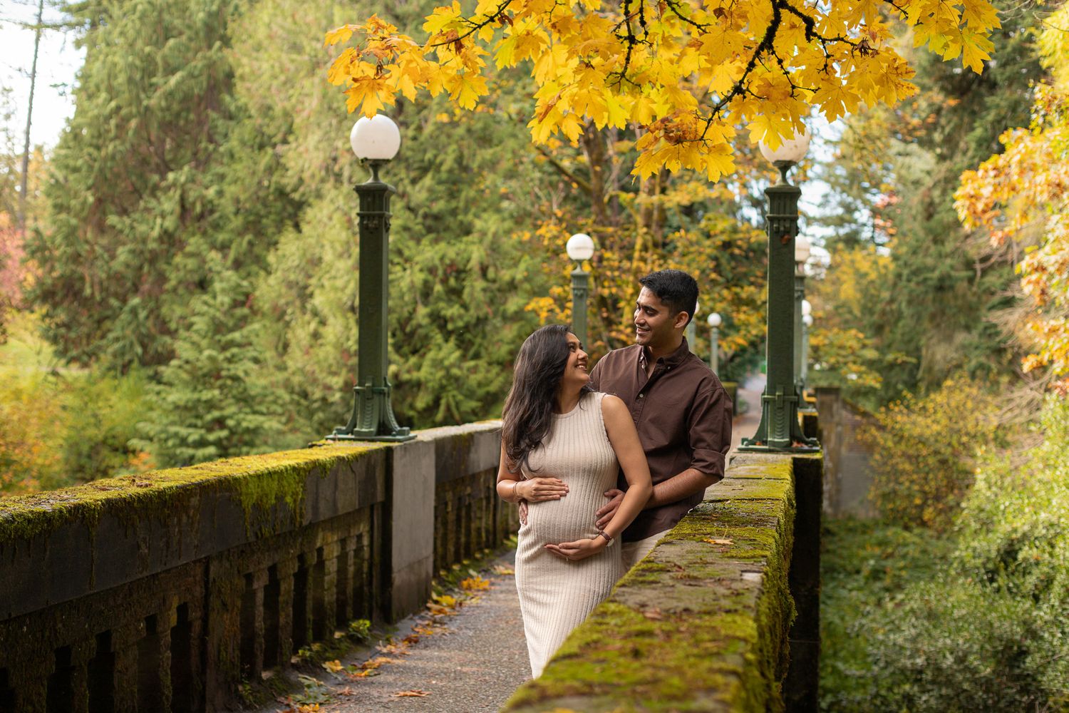 Romantic maternity couple session at Washington Park Arboretum, Seattle photographer capturing parents‑to‑be holding the baby bump