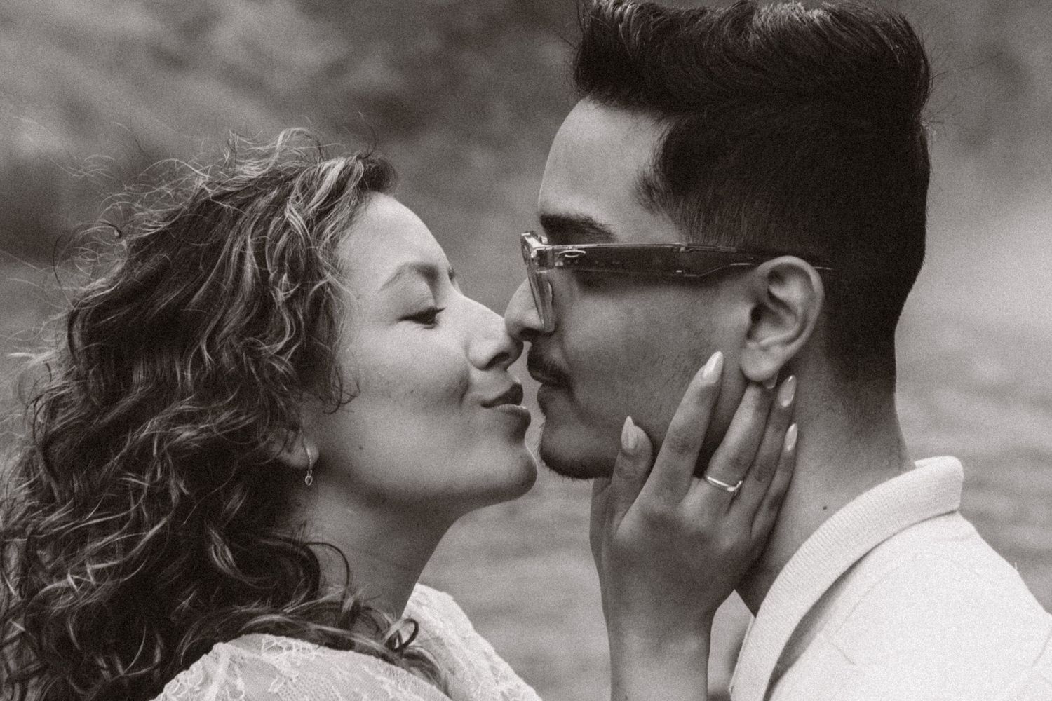 Black and white portrait of a newly engaged couple kissing after their Snoqualmie Falls proposal