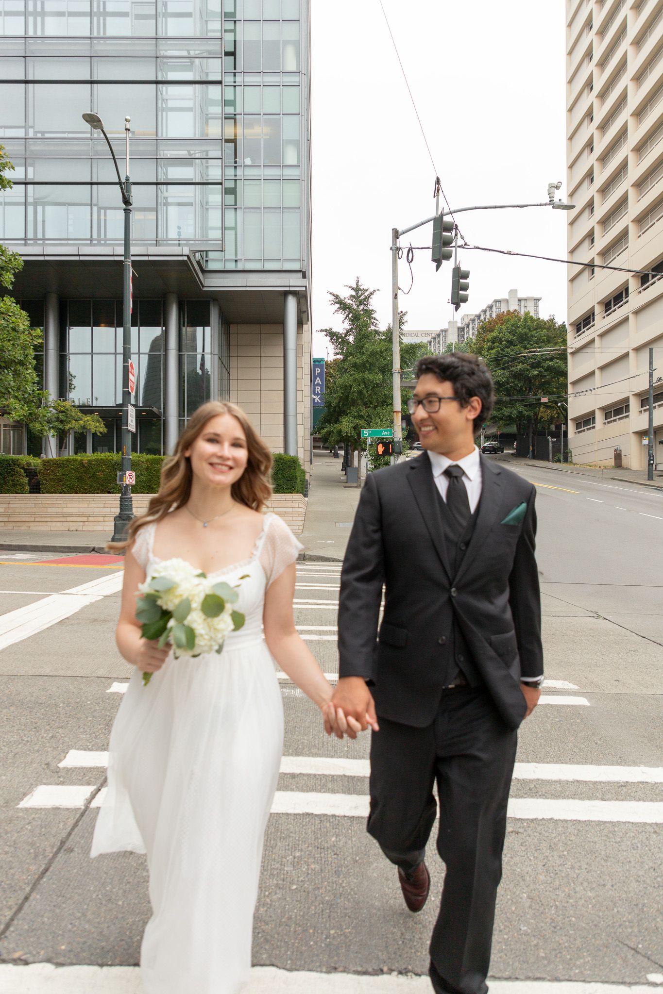 Urban Seattle elopement, couple leaving the courthouse and exploring downtown alleys and crosswalks for wedding portraits