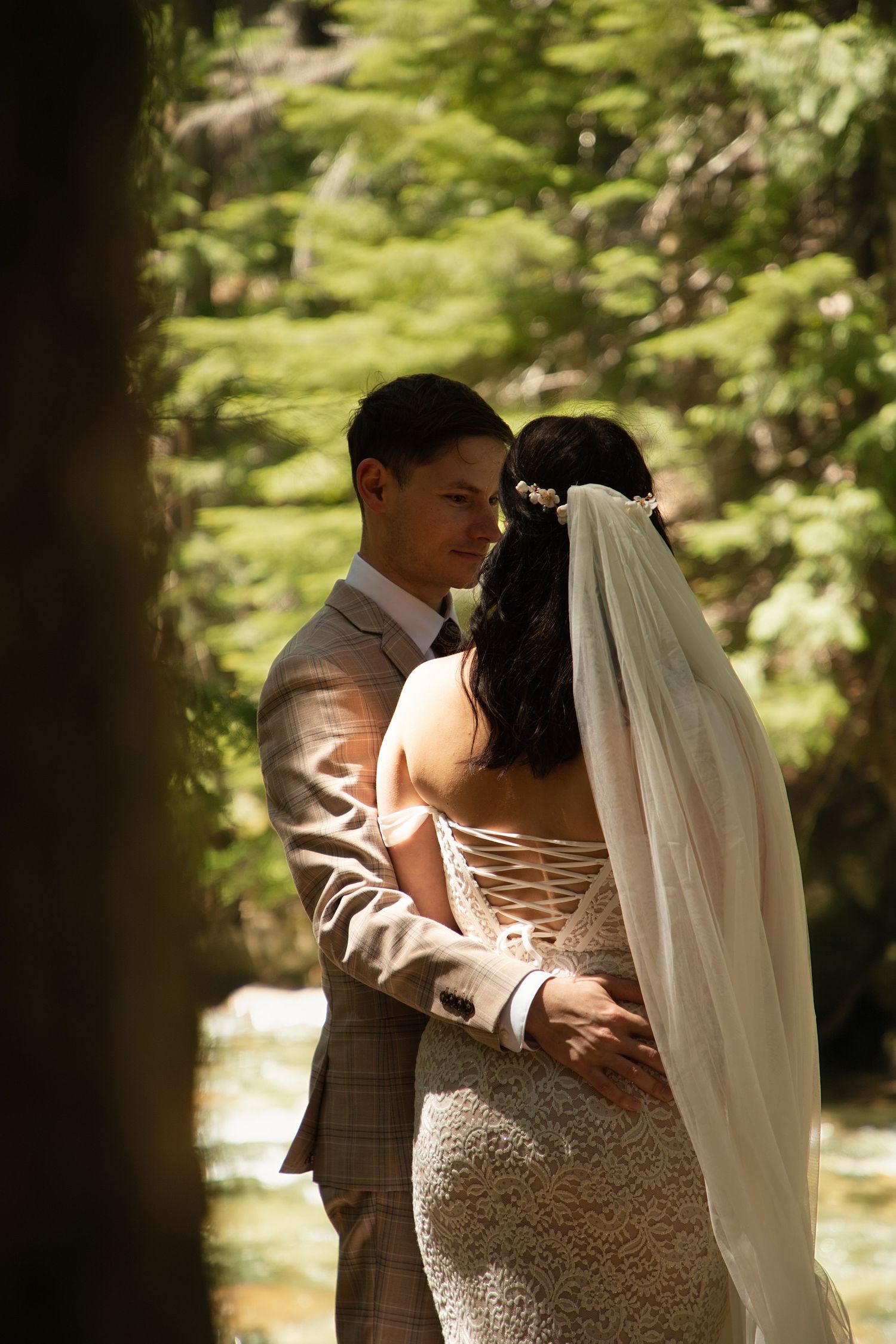 Intimate wedding couple embracing in a Pacific Northwest forest during a private elopement celebration